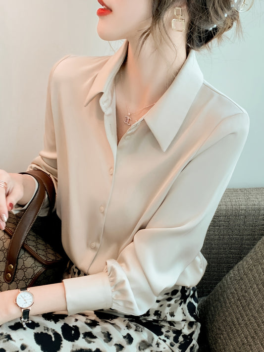 Women's chic solid color long sleeve blouse made of 100% polyester with lapel collar and button details. Suitable for all seasons.