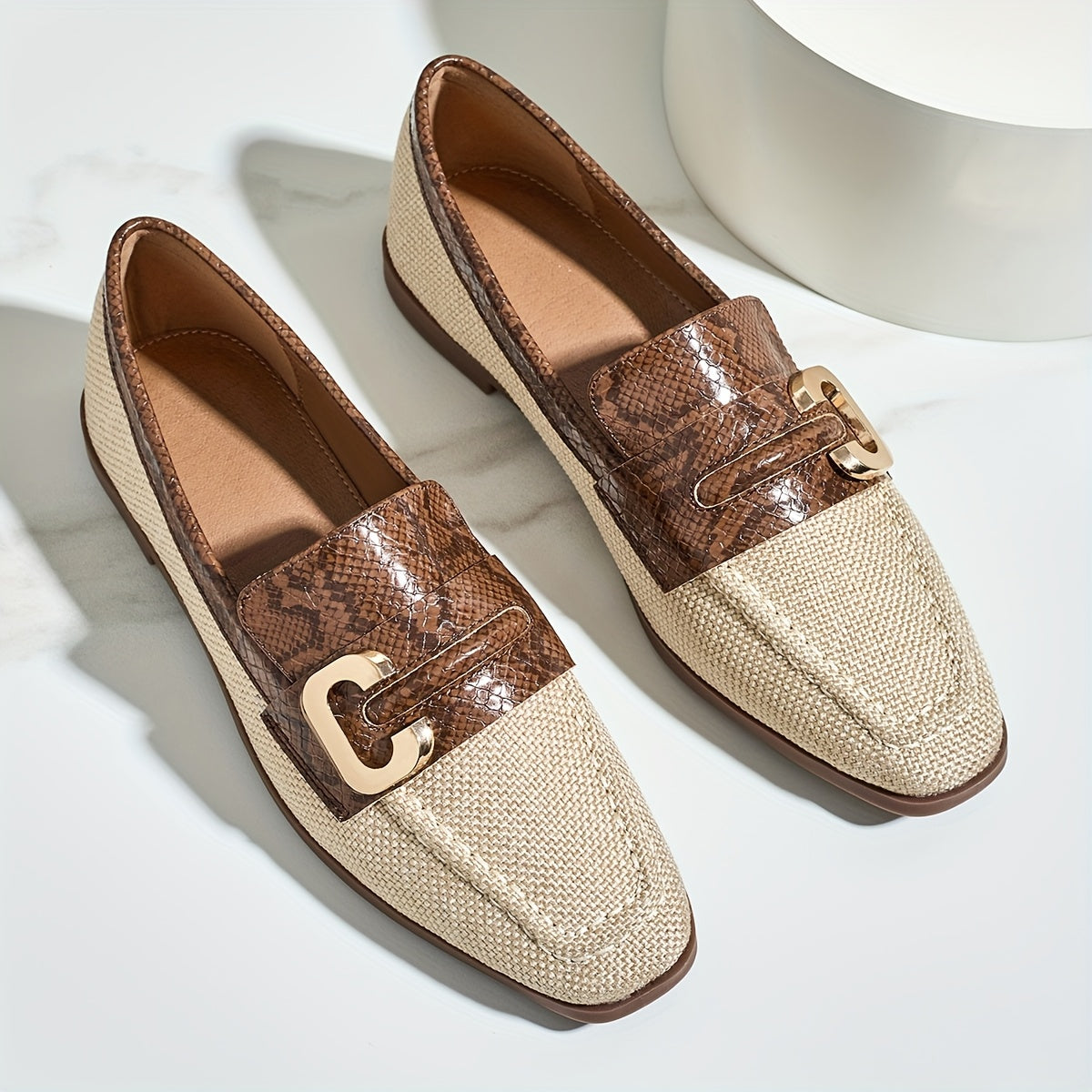 Women's brown snakeskin slip-on loafers with golden "C" buckle, lightweight sole, casual shoes.