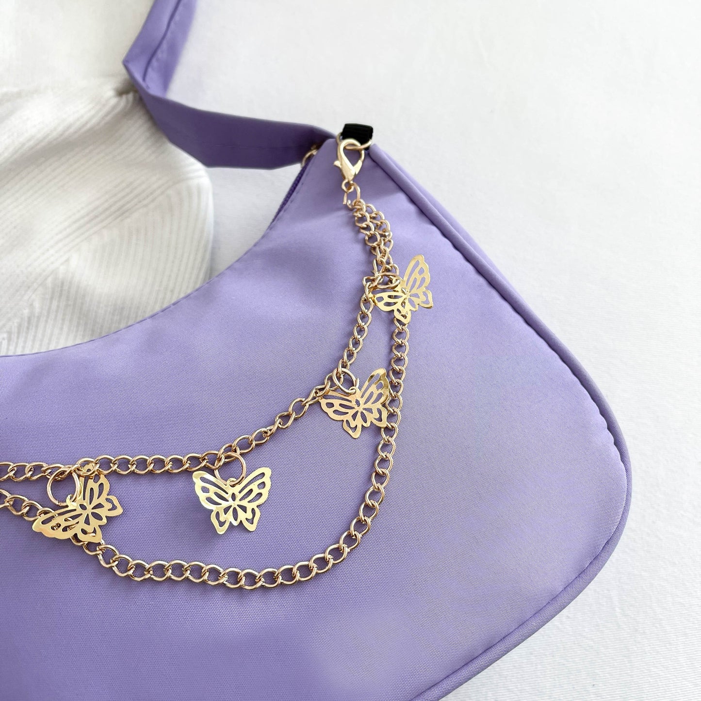 Stylish shoulder bag with butterfly chain, perfect for vacations, holidays, and parties.