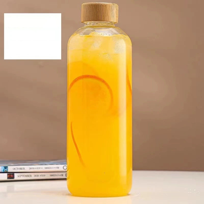 This borosilicate glass bottle comes with both a stainless steel lid and a wooden bamboo lid, making it perfect for travel and storing a variety of beverages such as juice, smoothies, kombucha, kefir, and tea. It is 100% leakproof and can be safely used