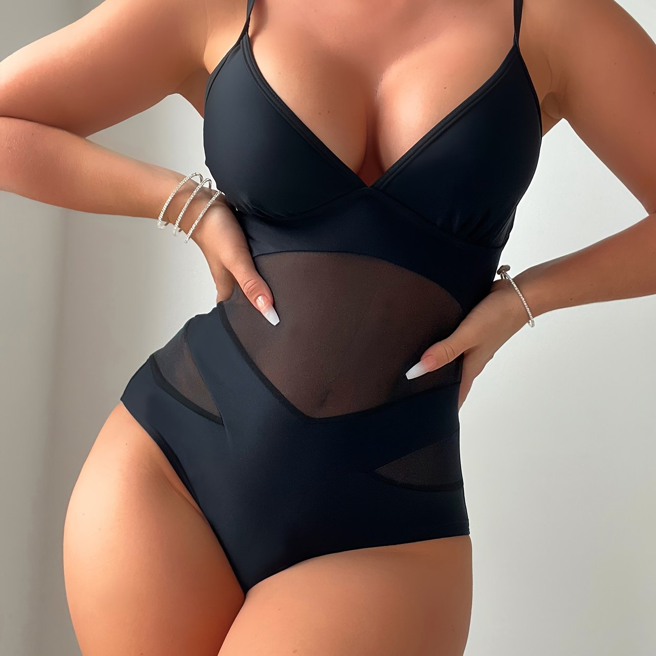 Seductive one-piece swimsuits with mesh high waist, plunging V-neck, and cut-out details.