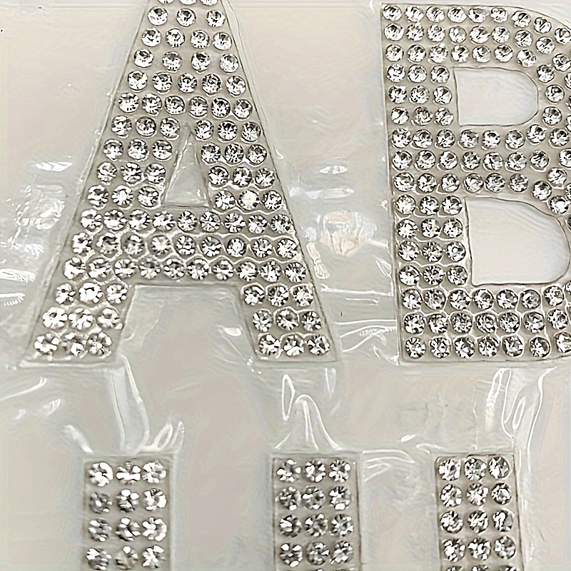 26 pieces of self-adhesive silvery rhinestone letters from A to Z, backed with iron and made of glass. Perfect for DIY projects on clothing, shoes, hats, car decorations, and other hobby crafting activities. Mix and match to personalize your items with a