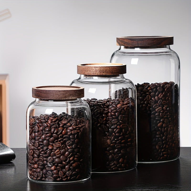 Large glass food storage jars with airtight wooden lids for storing coffee beans, dried food, pasta, tea leaves, overnight oats, grains, and spices. These clear glass canisters are perfect for organizing your kitchen and keeping your ingredients fresh.