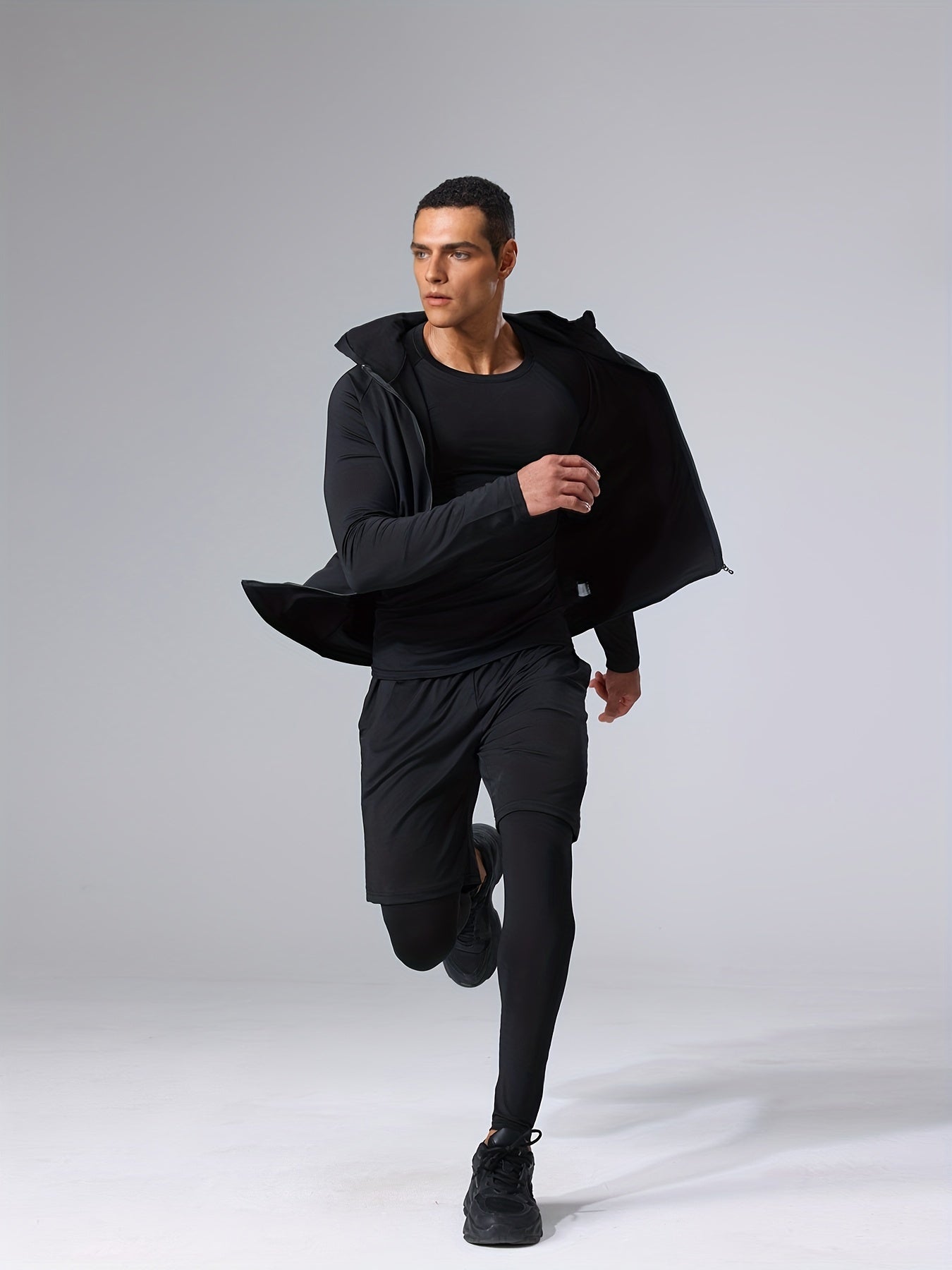 Polyester and elastane blend athletic set includes crew neck hoodie and skinny fit bottoms for running, fitness, cycling, and outdoor activities.