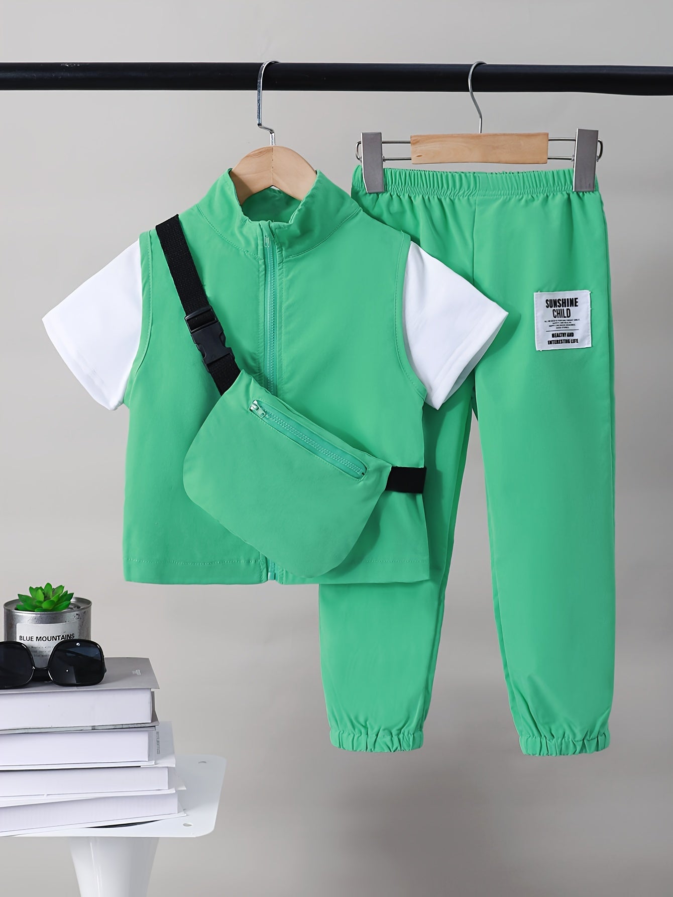 Boys 4-piece spring outfit: Short sleeve t-shirt, sleeveless vest, cargo pants, and crossbody bag. Cool, lightweight, and comfy for outdoor wear.