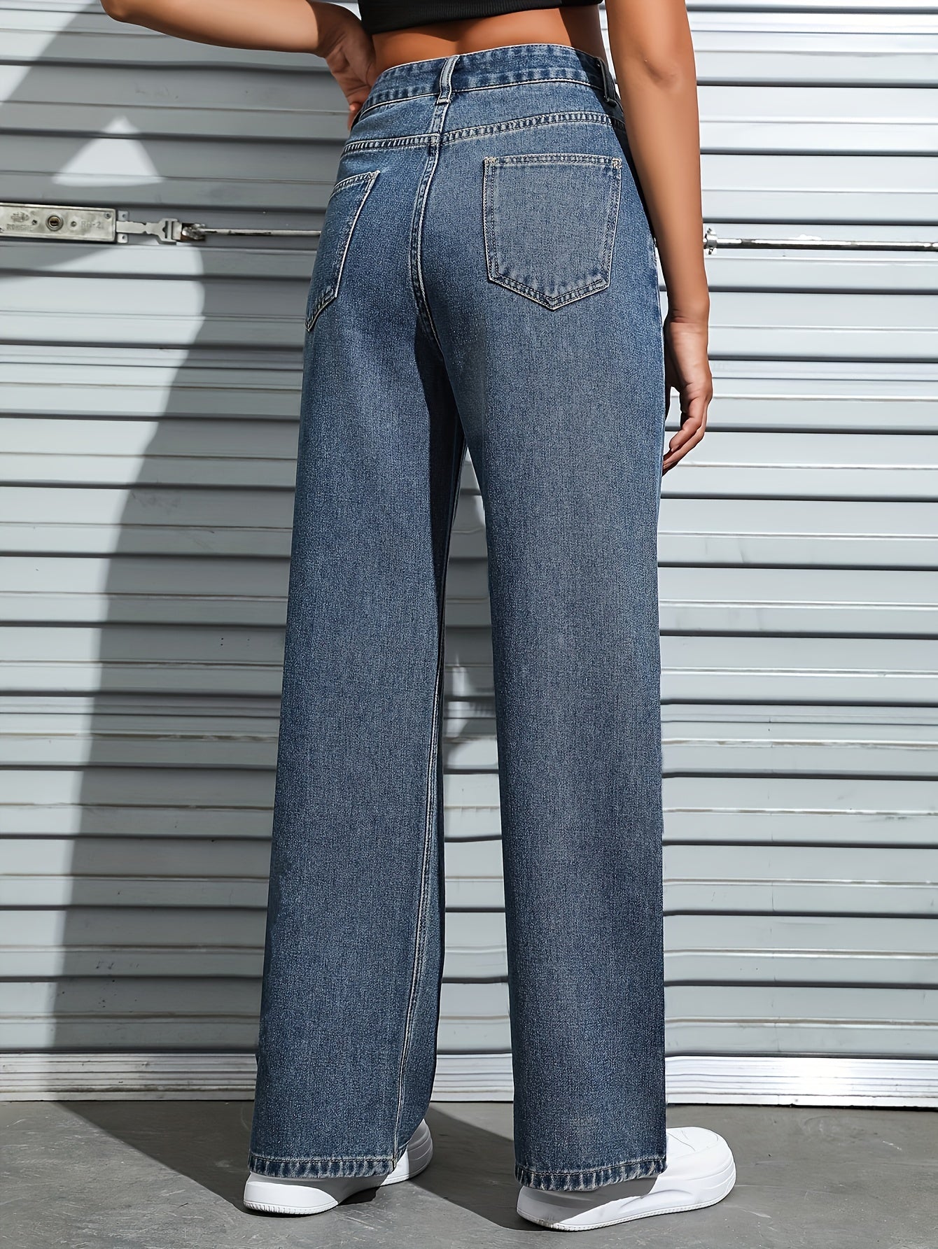 Women's plain washed blue loose fit jeans with slash pockets, perfect for casual autumn wear.