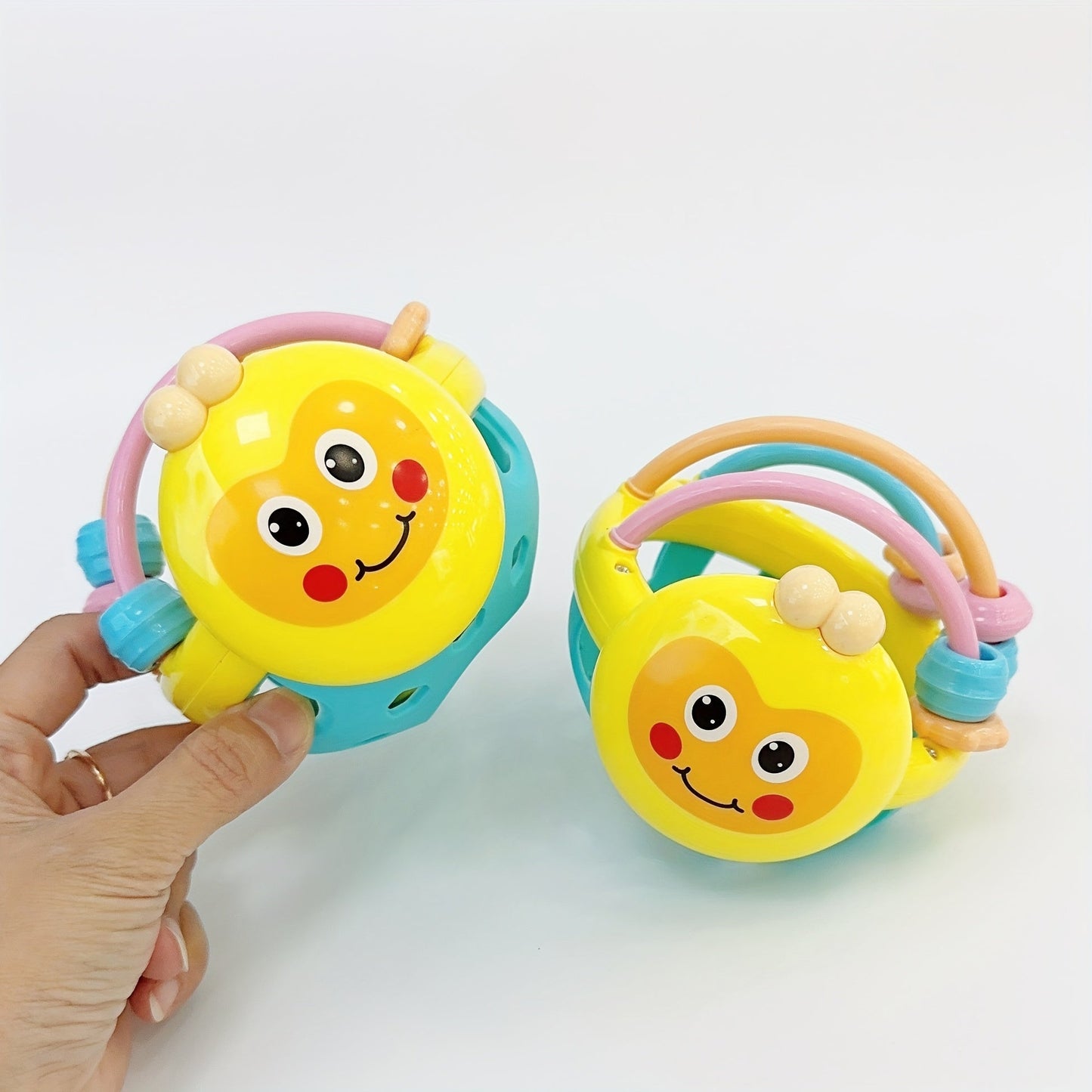 Toys like rattles, gripping toys, teething toys, and handheld balls.