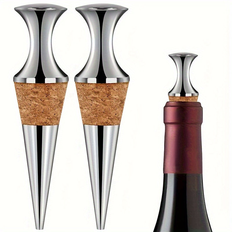 Two silver wine stoppers with wooden plugs.