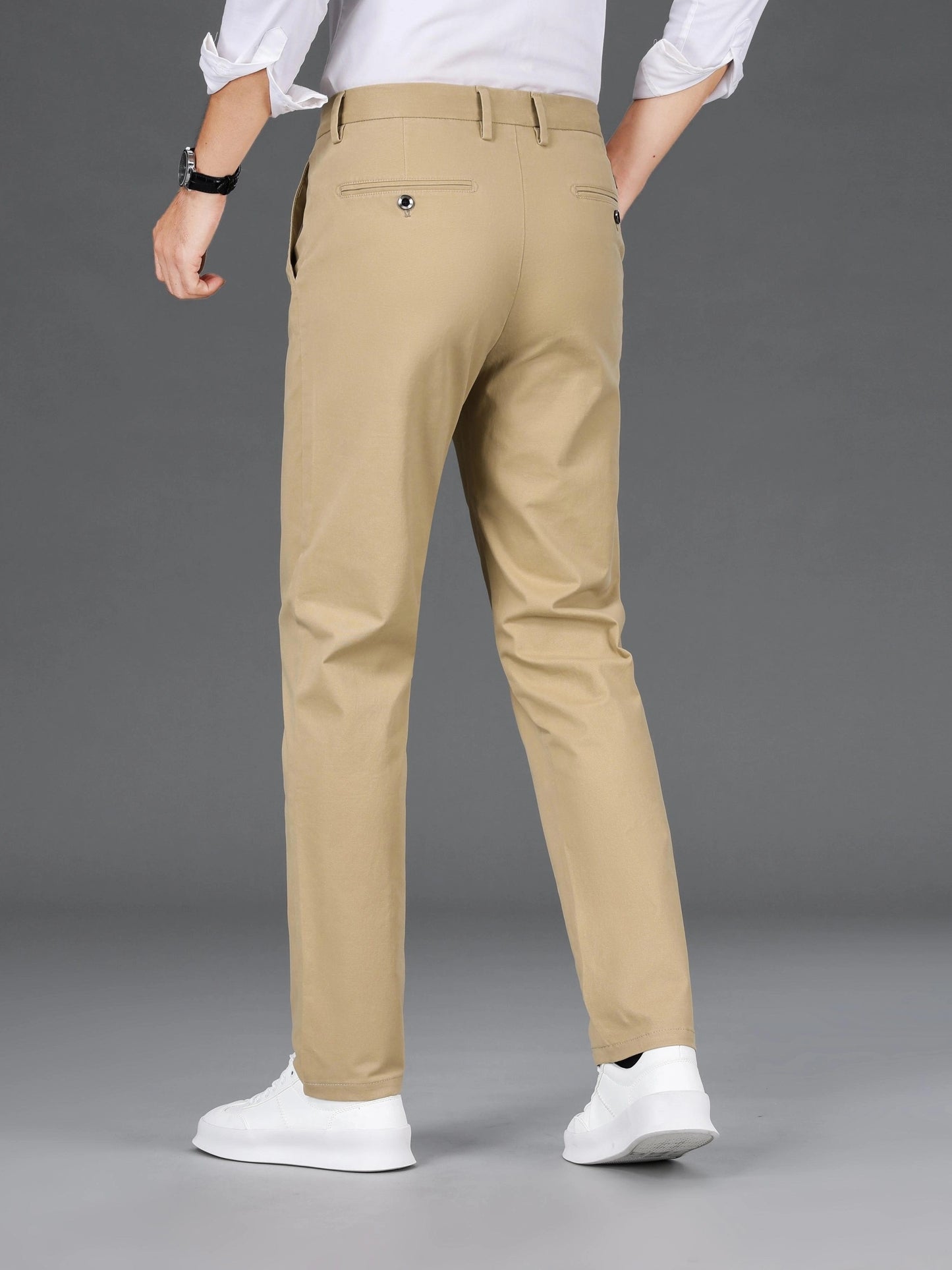 Men's slim-fit cotton blend trousers in solid color, suitable for business casual wear throughout the year. Features micro-elastic fabric, pockets, and regular length.