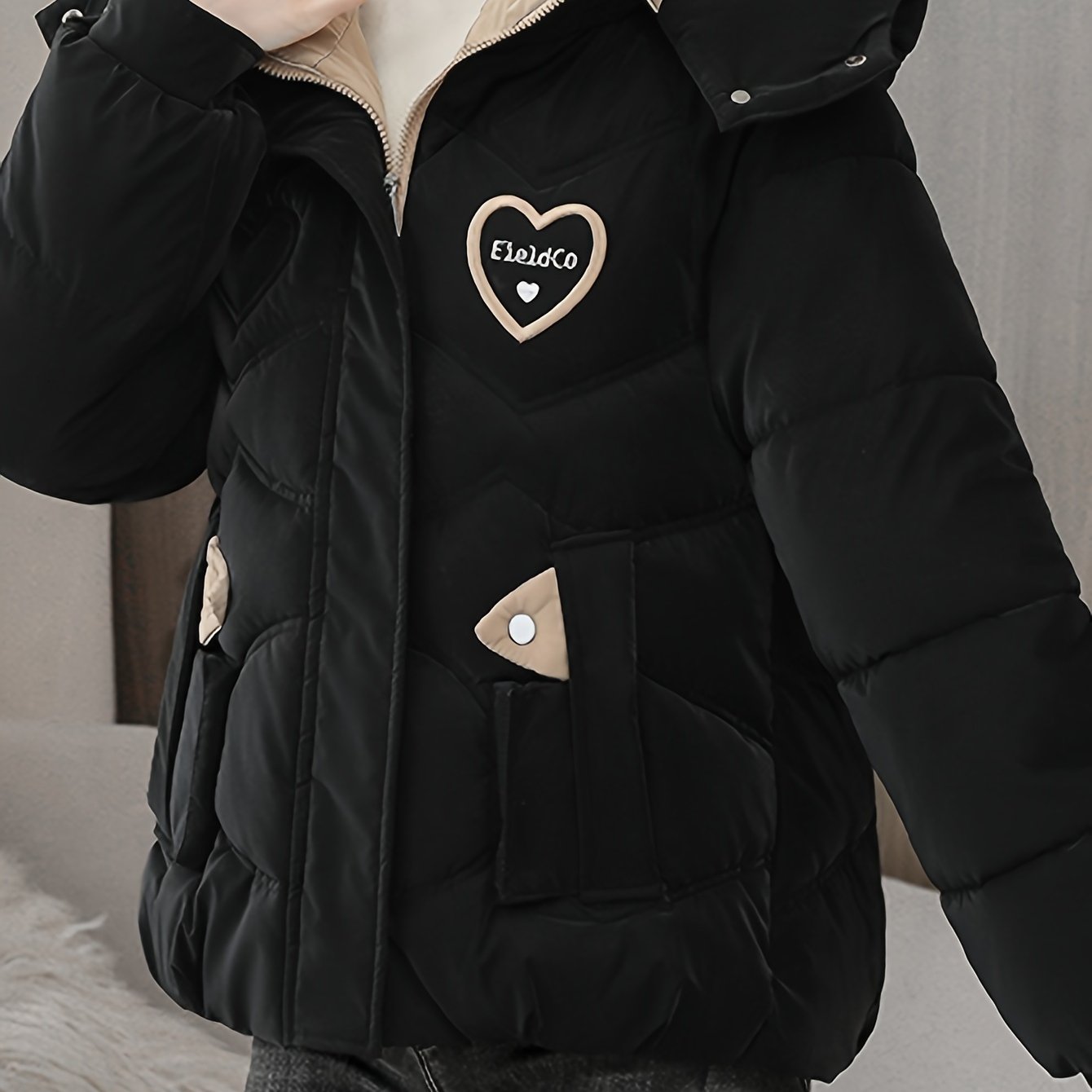 Stylish black winter jacket for women - Thick polyester with fashionable hood and heart logo detail, perfect for casual moms and ladies. Zipper closure.