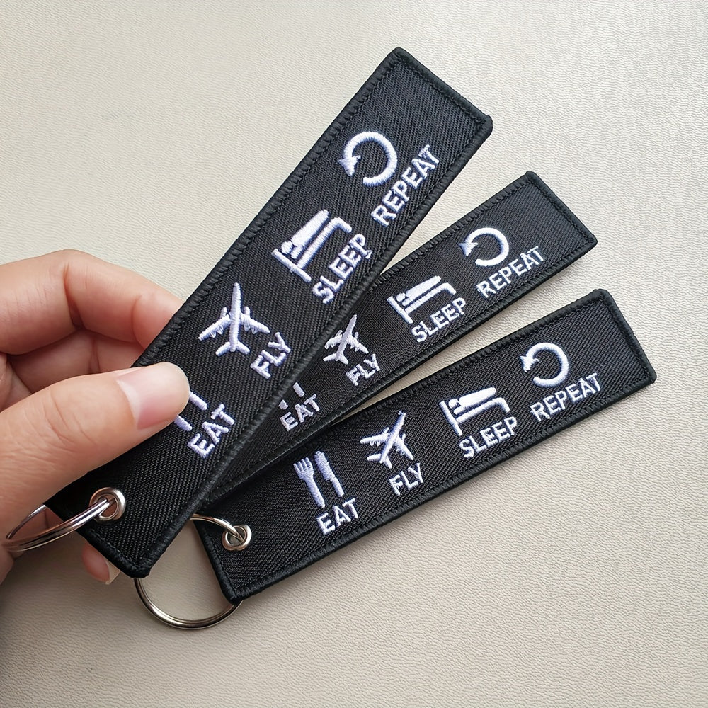 Set of three 'Eat Fly Sleep Repeat' keychains with embroidered design. Ideal gift for pilots, aviation enthusiasts, or anyone with a sense of humor. Keychains come in black and white color combination.