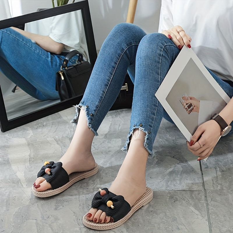 Women's PVC slip-on sandals with bow and bead accents, flat heel, open toe, ideal for beach wear.  Bow embellished, made from synthetic material.