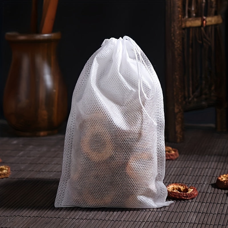 100 pieces of high-quality disposable tea and coffee filter bags with a convenient drawstring closure - ideal for brewing loose leaf tea, aromatic teas, and spices.