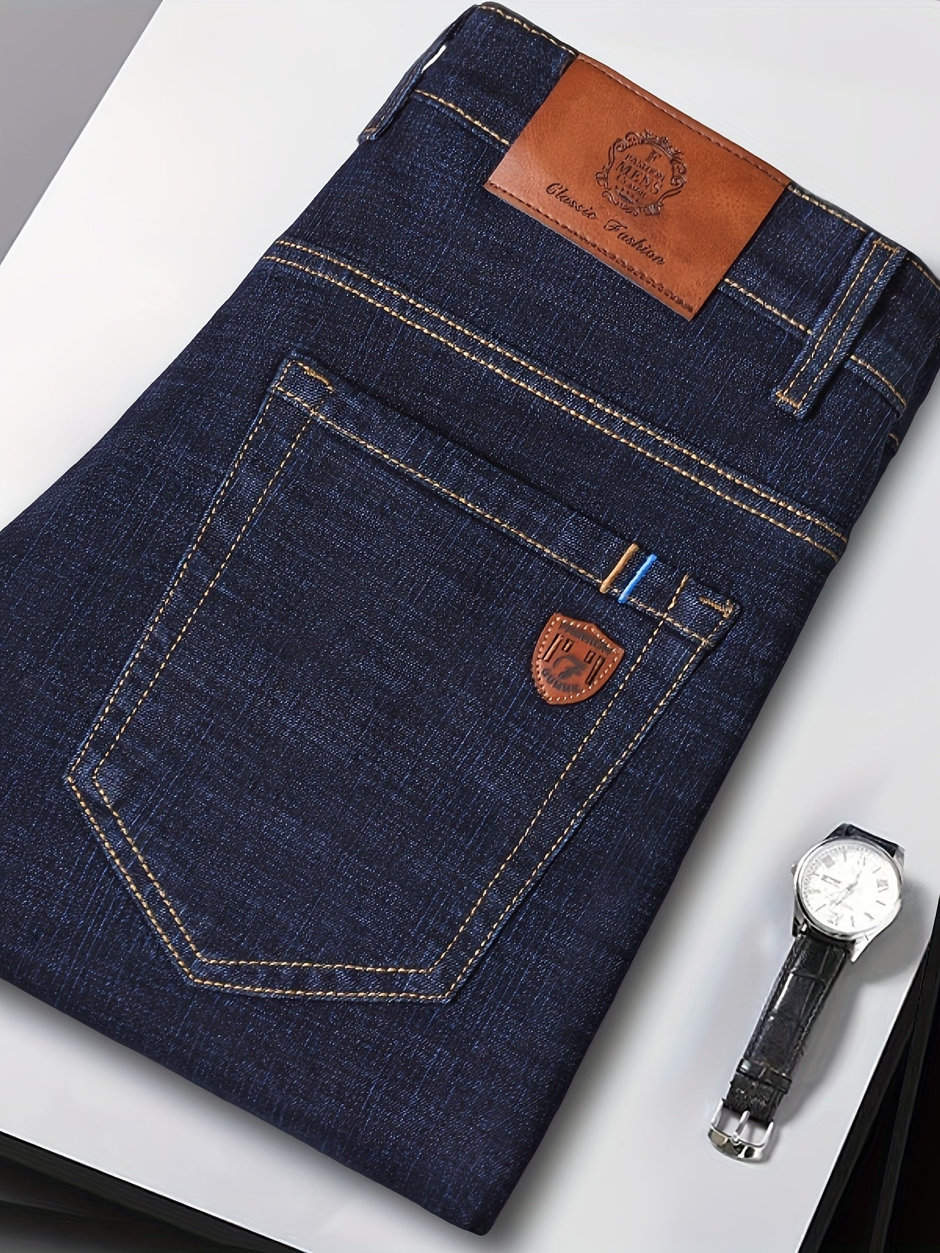 Men's slim-fit jeans made of 61.6% cotton, 36.9% polyester, and 1.5% spandex with all-season stretch denim. Raw wash in a solid color, regular fit for casual weekends. 200gsm woven fabric.