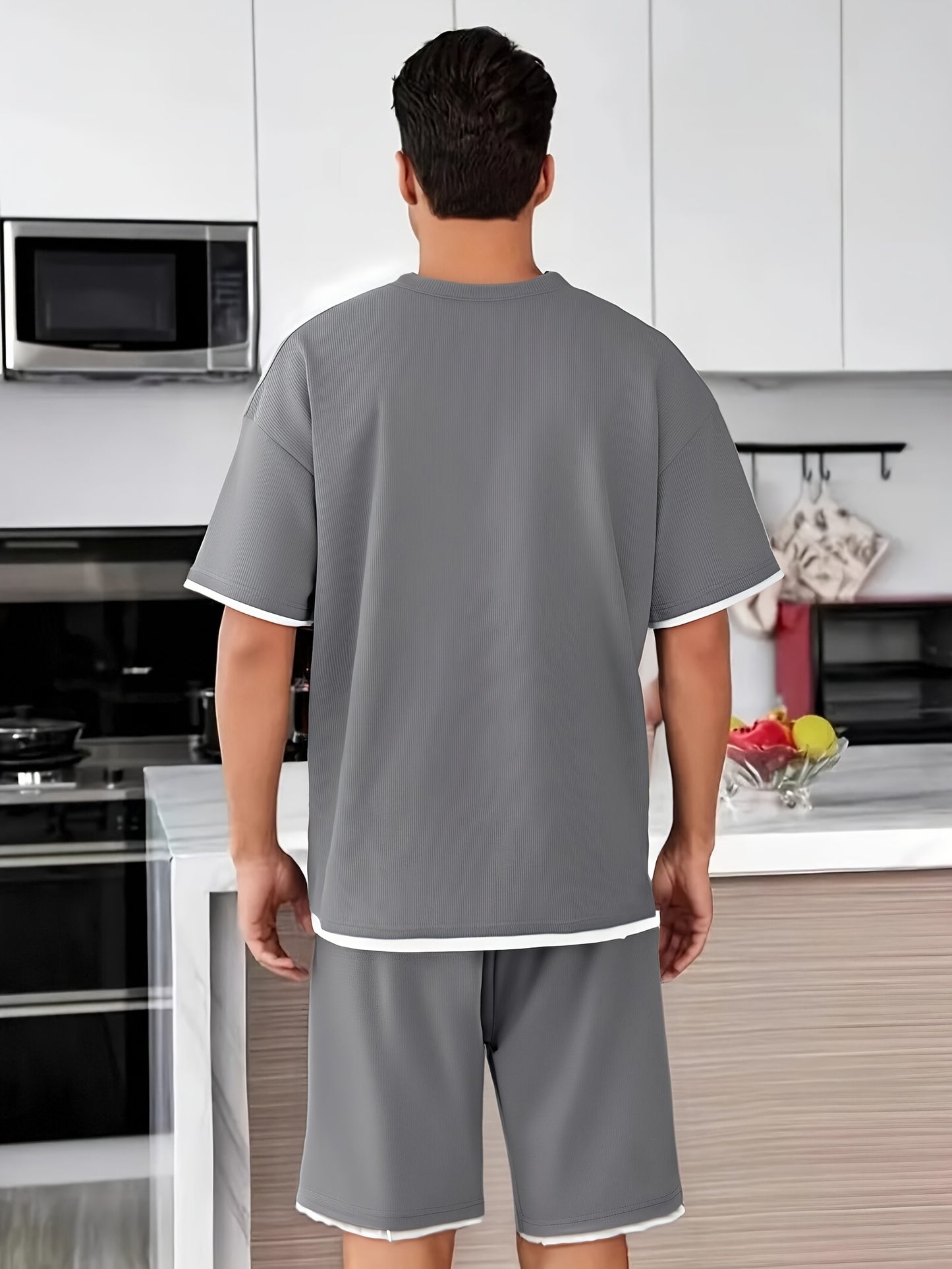 Men's casual waffle knit pajama set in gray and black with short sleeve top and elastic waist shorts. Features applique detailing and soft polyester fabric for comfort.