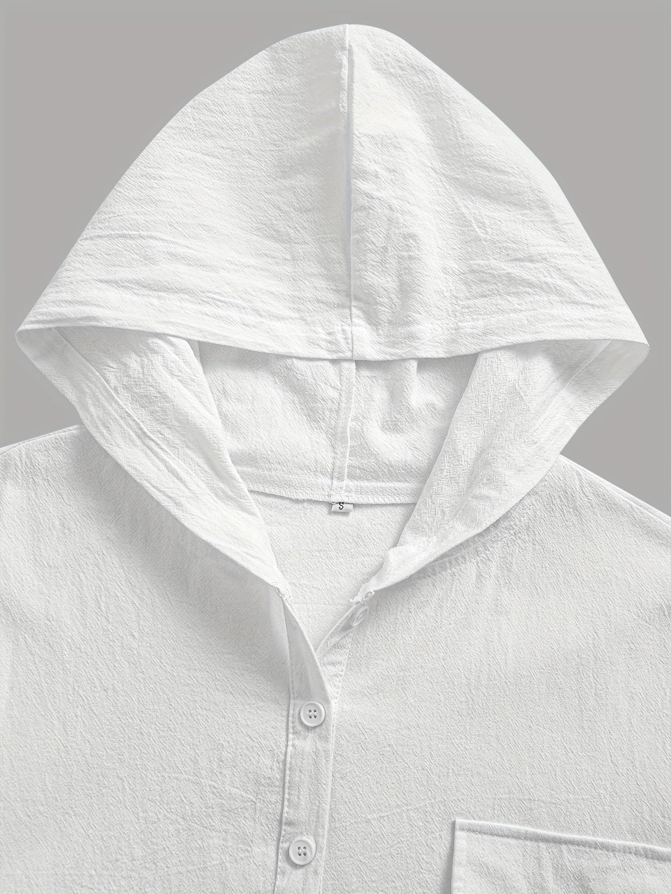 Loose-fitting short-sleeve top with hood and button closure.