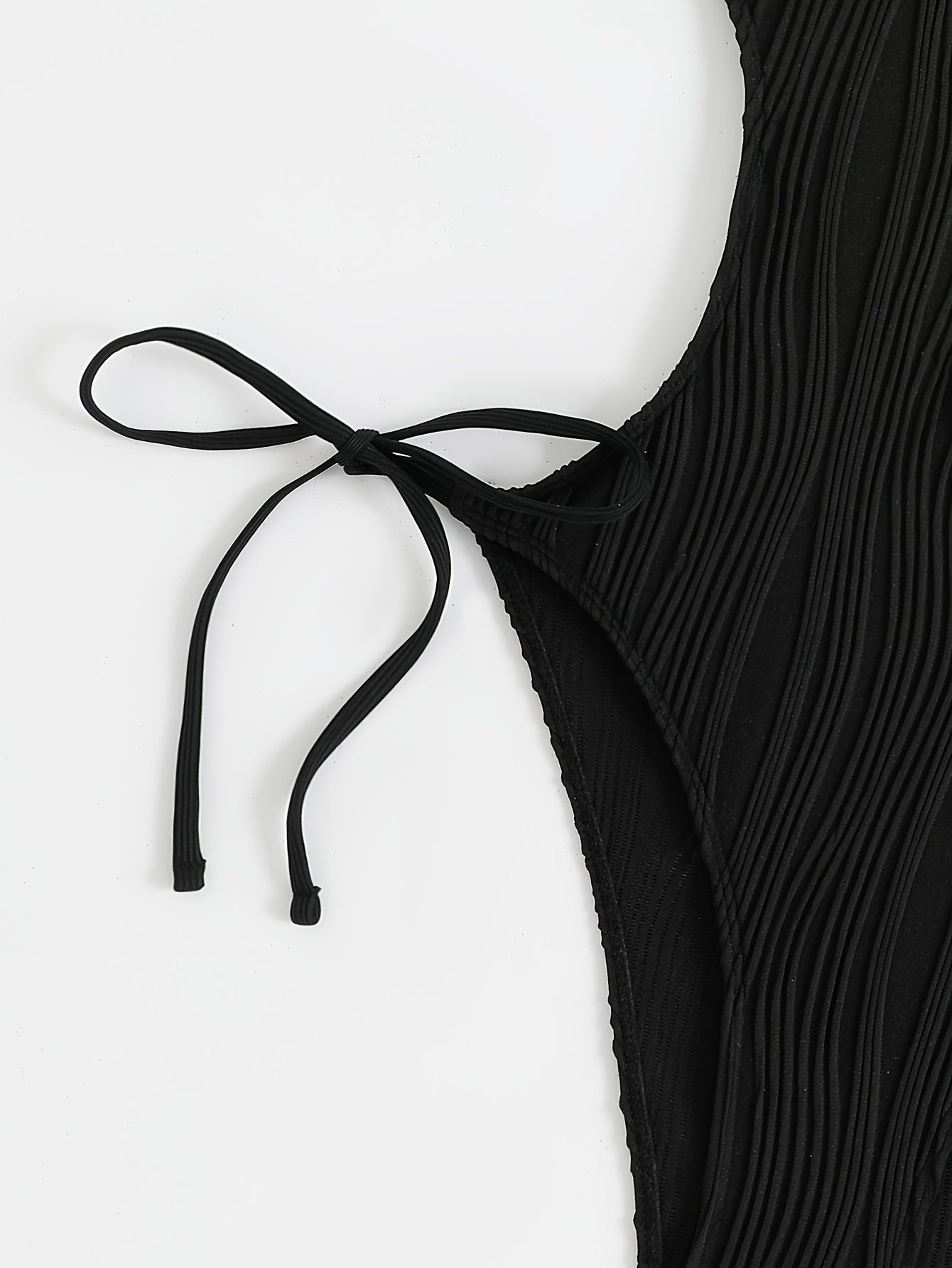 Sexy, high stretch backless halter one-piece swimsuit for women with tie detail; machine washable.