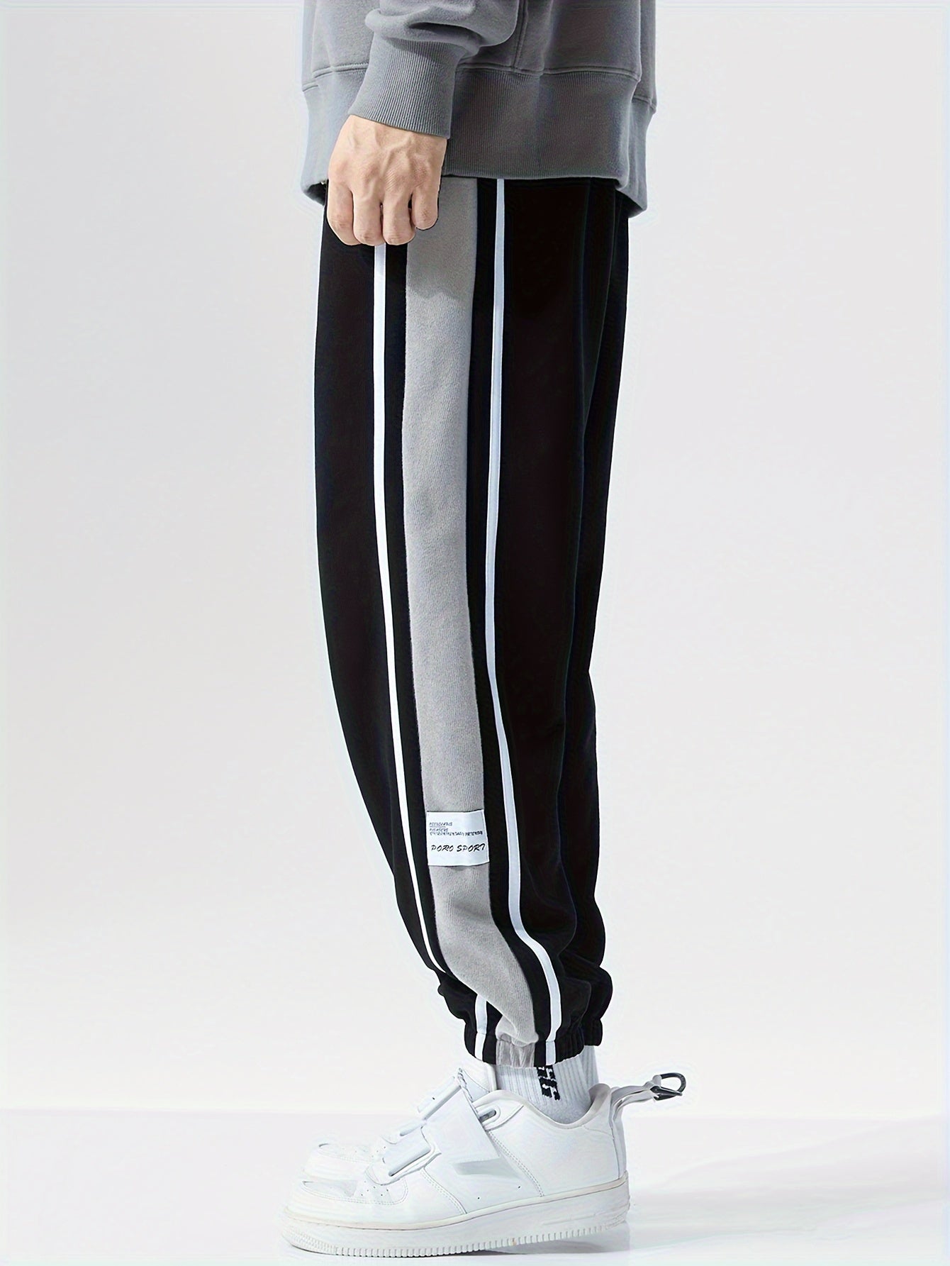 Men's loose sports pants for summer and fall, trendy style, available in large sizes, suitable for casual wear.