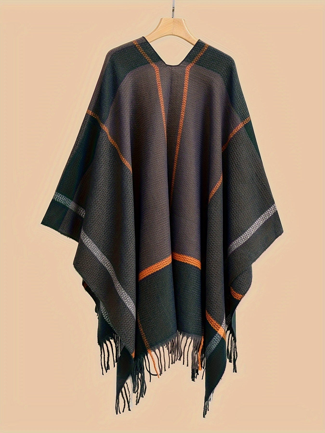 Stylish plus size shawl cardigan with tassels for fall/winter parties features v-neck, asymmetrical hem, and geometric pattern.