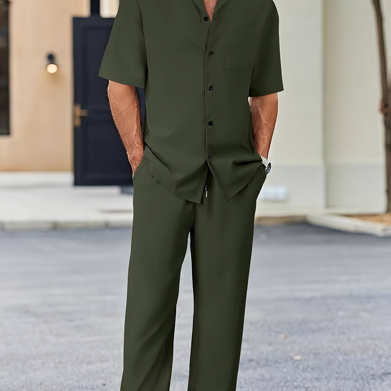 Men's casual suit-inspired set includes short sleeve shirt and loose straight pants made of polyester, machine washable.