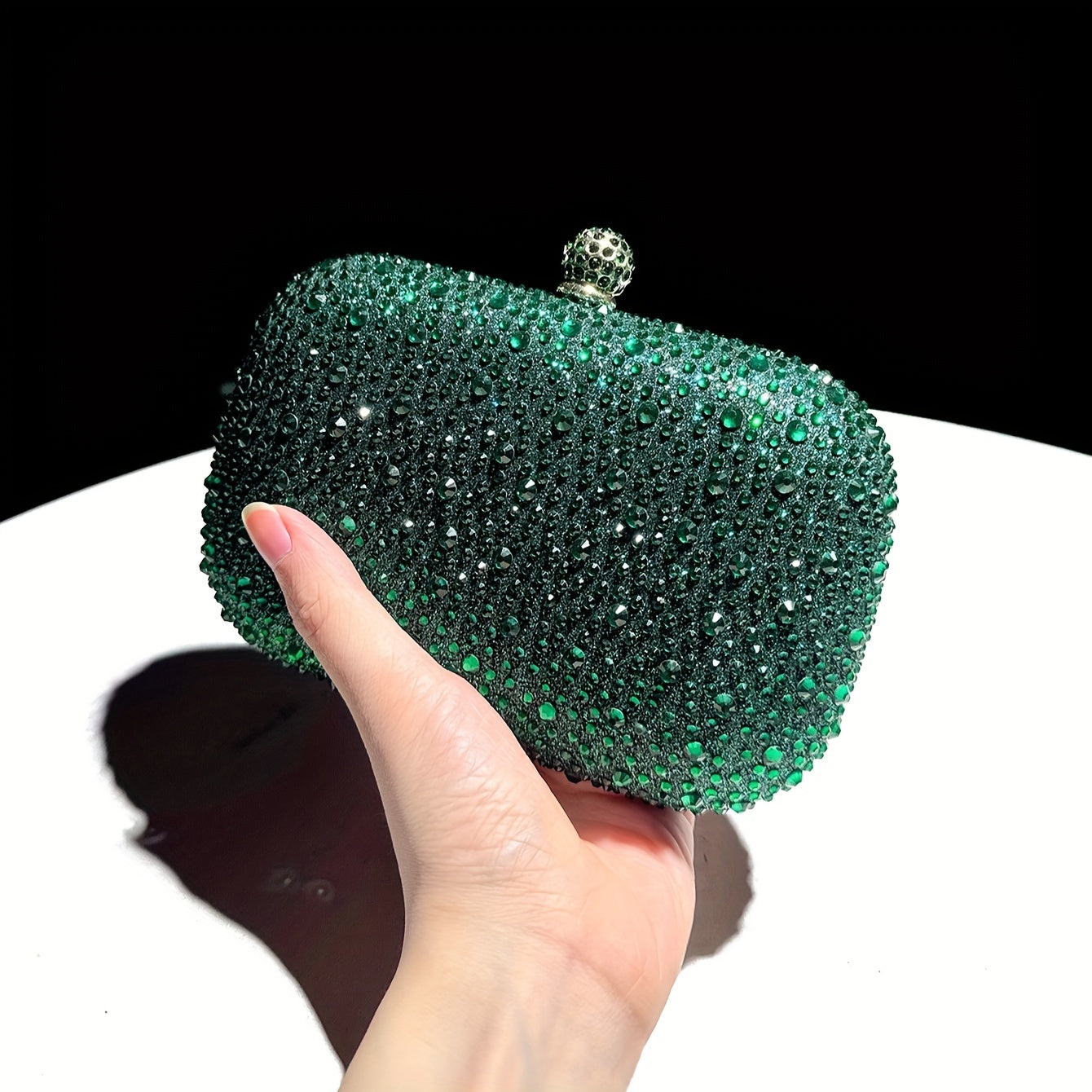 Stylish emerald green handbag with golden chain, suitable for formal events and as a gift for women.