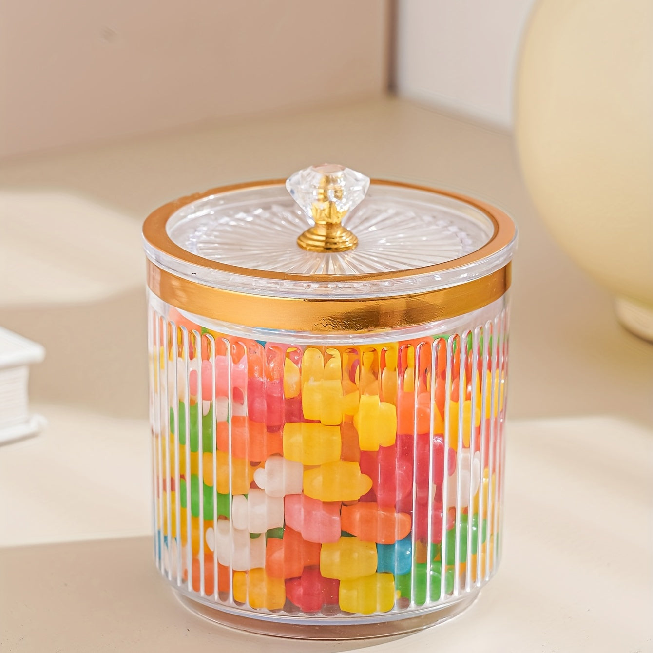 One piece of a transparent amber sketch golden grey bead decorated jar with a lid for candies. Made of plastic, can only be hand washed. It is a reusable sealed fresh-keeping box for storing cereal, rice, pasta, tea, nuts, and coffee beans. Perfect for