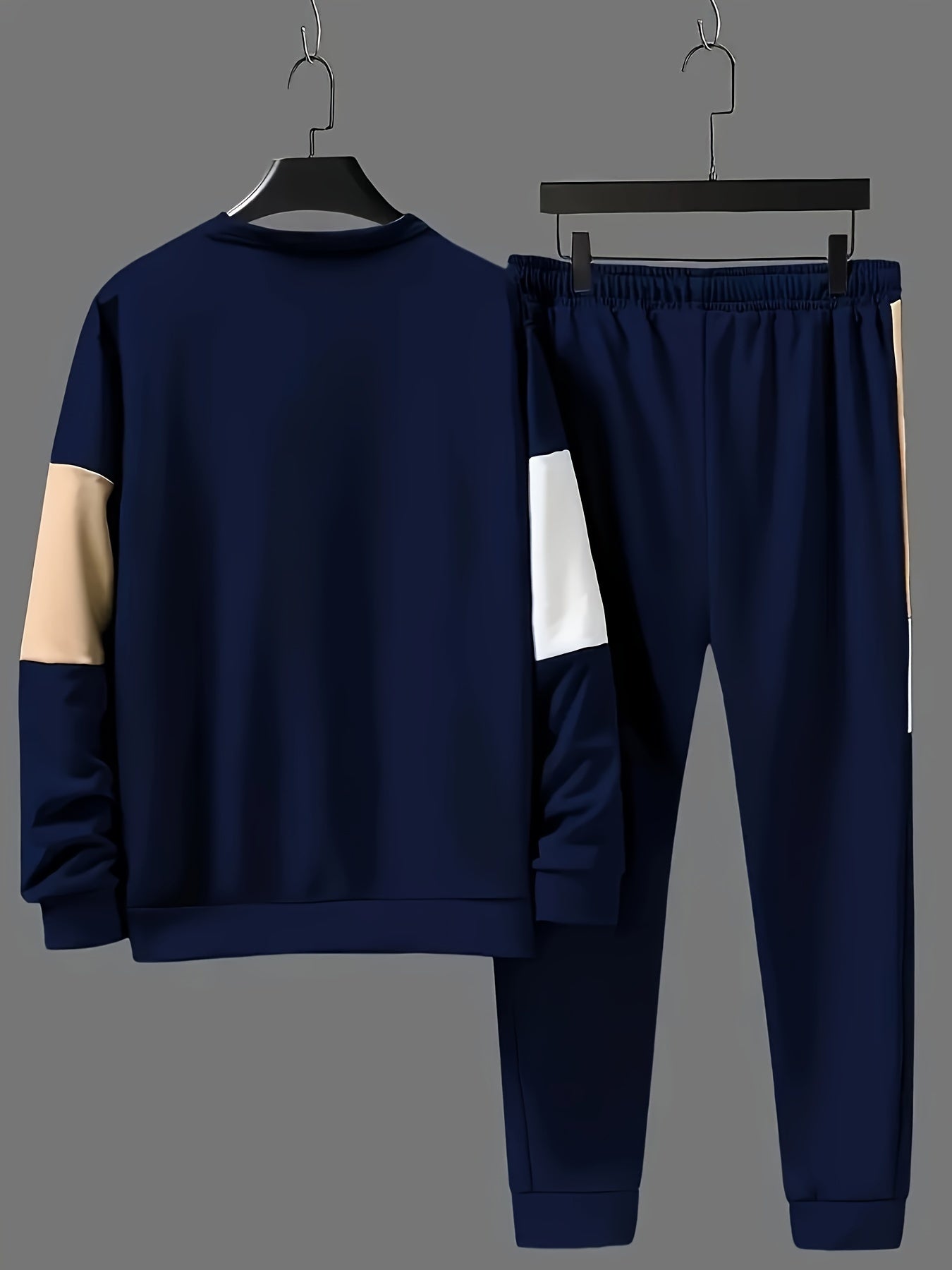 Casual men's outfit includes color block sweatshirt and drawstring pants.