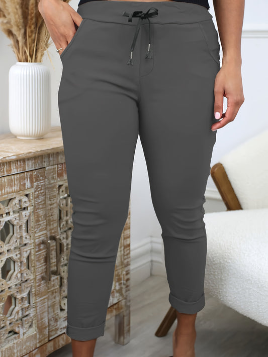 Women's comfortable jogger pants made of stretchy polyester with a drawstring waist, solid color, and machine washable for all-season wear.