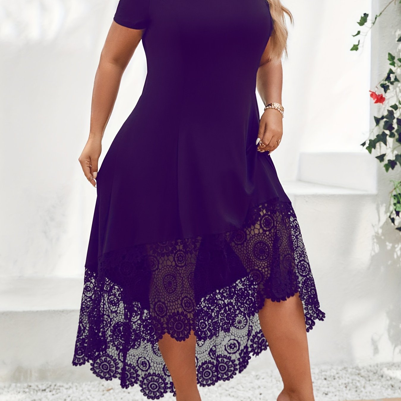 Stylish plus size black dress with white lace panel features off-shoulder design, short sleeves, and asymmetrical hem. Made of medium stretch, machine washable fabric, this dress is ideal