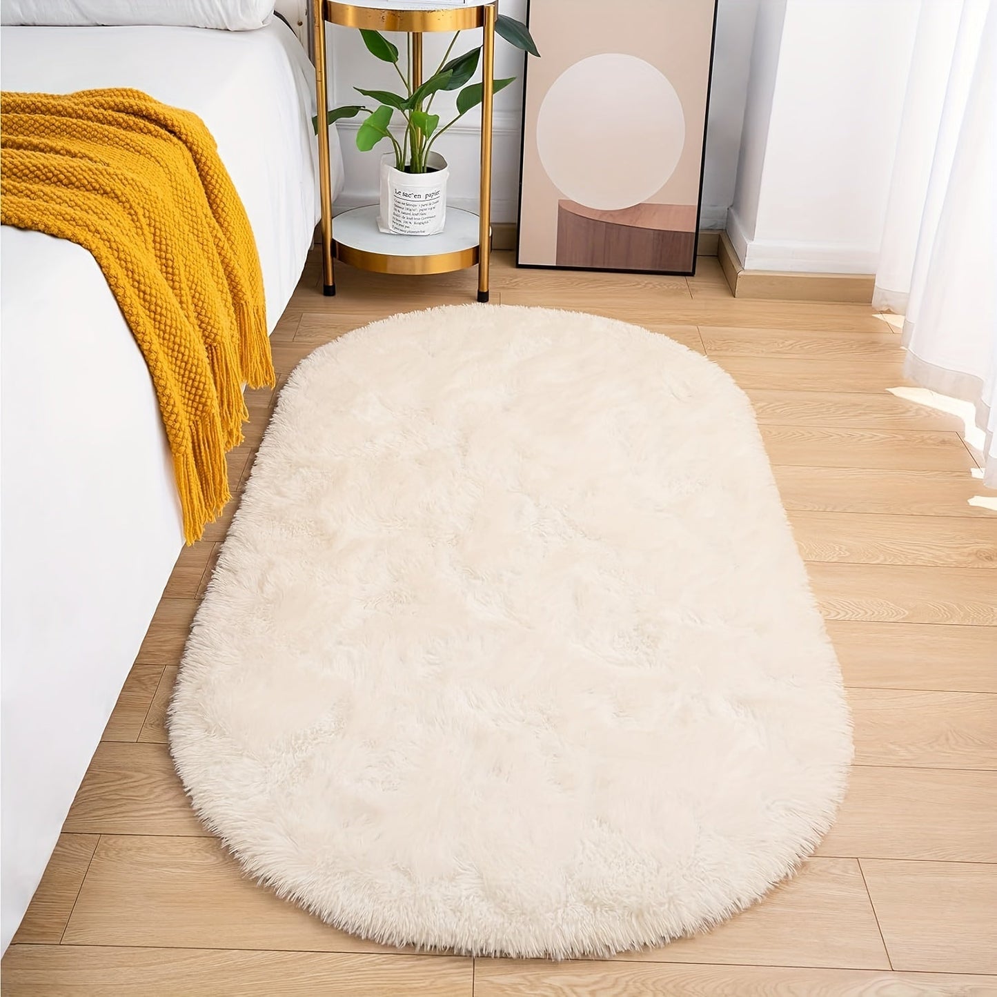 Soft and fluffy oval shaggy area rug, perfect for bedroom or living room. Made with skin-friendly thickened sponge and tufted polyester material. Durable and easy to maintain. Adds decorative touch to indoor spaces such as sofa, bedside, playroom, or