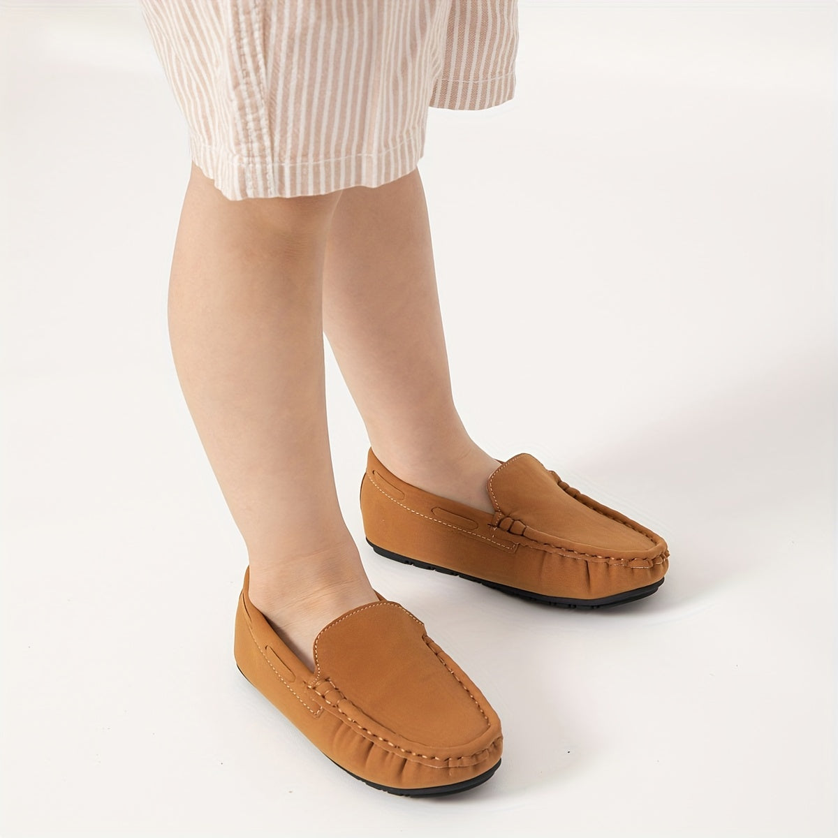 Boys' slip-on loafers in black and brown, suitable for all activities.