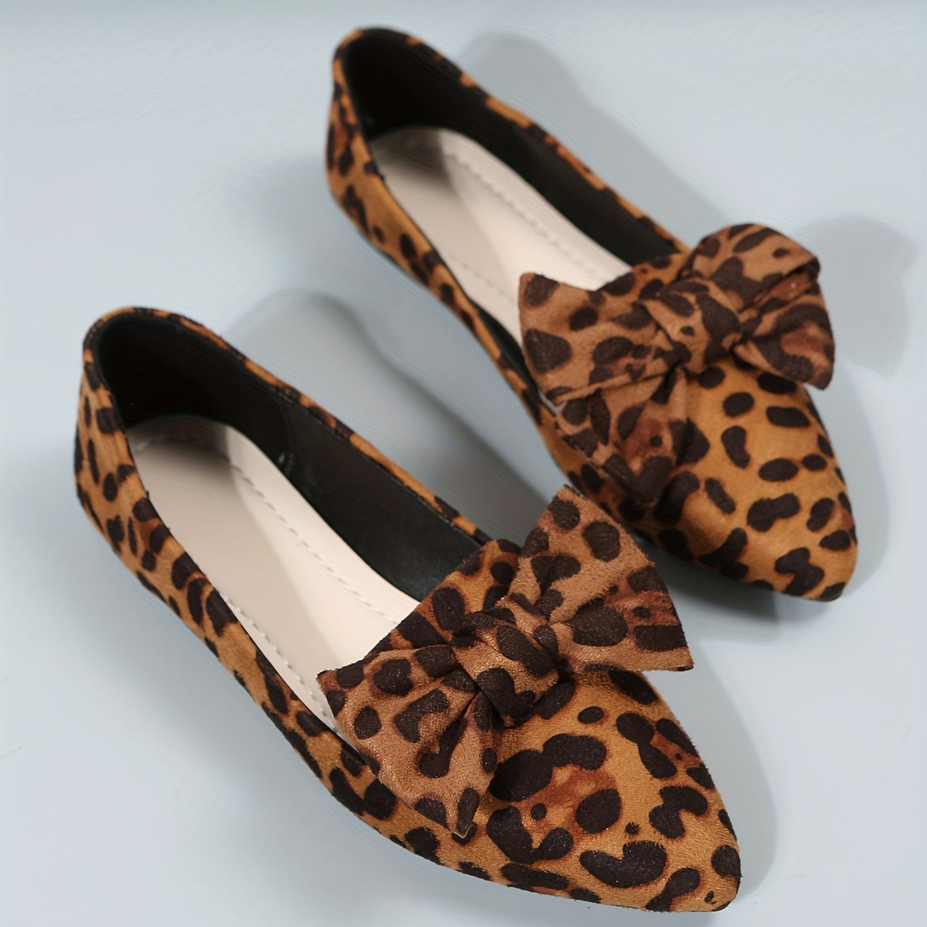 Leopard print flat shoes with bowknot decor and point toe, lightweight slip on style.