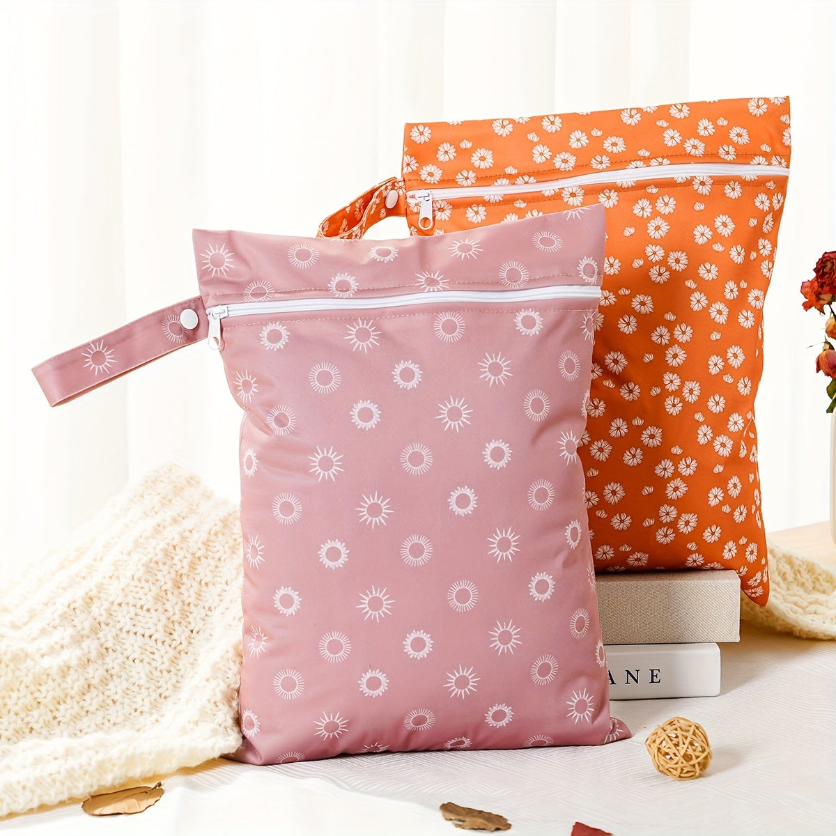 Two waterproof wet bags that are washable and can be used as diaper bags. They are multi-purpose nappy storage bags that also function as wet/dry bags.