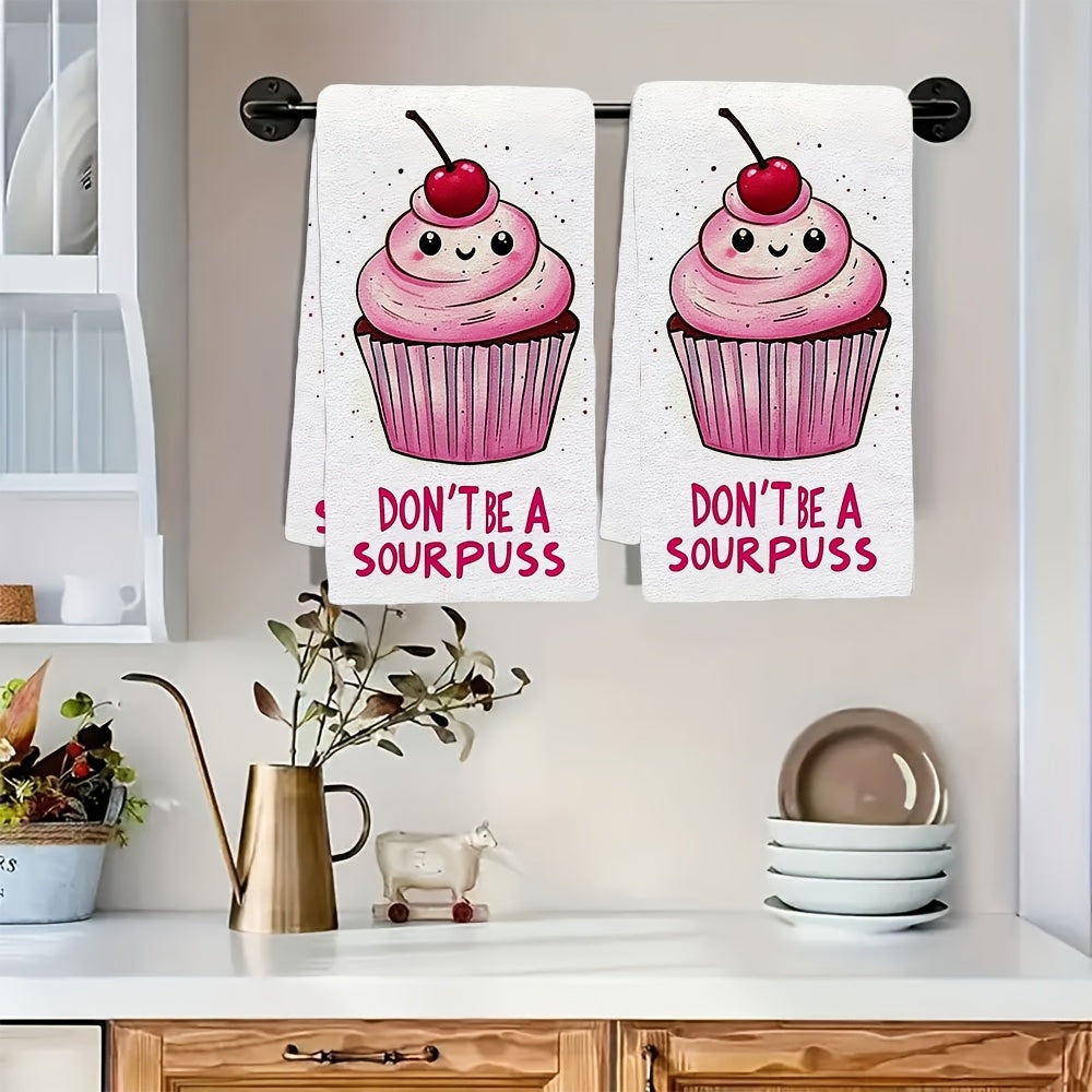 2 pieces of ultra soft kitchen towels featuring a "Don't Be A Sourpuss" cupcake design. These highly absorbent and machine washable dish hand towels have a contemporary style with pink and white stripes. Measuring 40.64x60.96 cm, they are perfect for