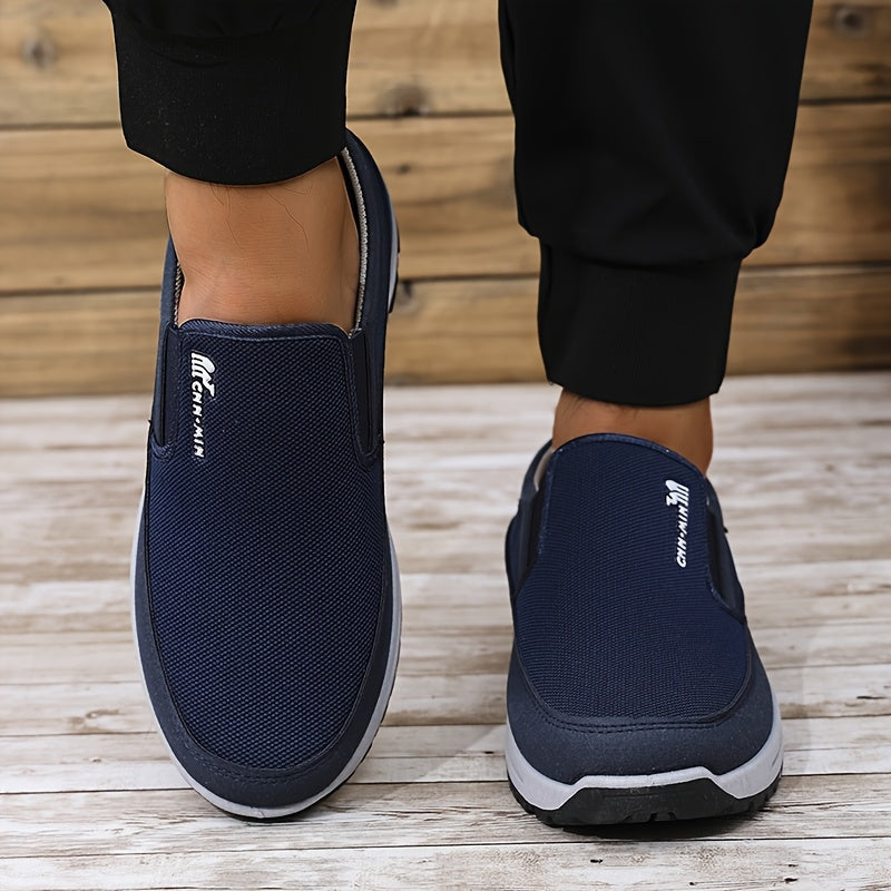 Men's slip-on sports sneakers with breathable fabric upper, round toe, and faux sole for daily wear and running.