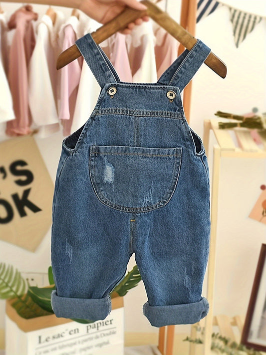 Kids' denim overalls in a solid color with a casual, loose fit, made from a cotton blend. Features pockets and is perfect for outdoor activities in spring or fall. Suitable for both boys