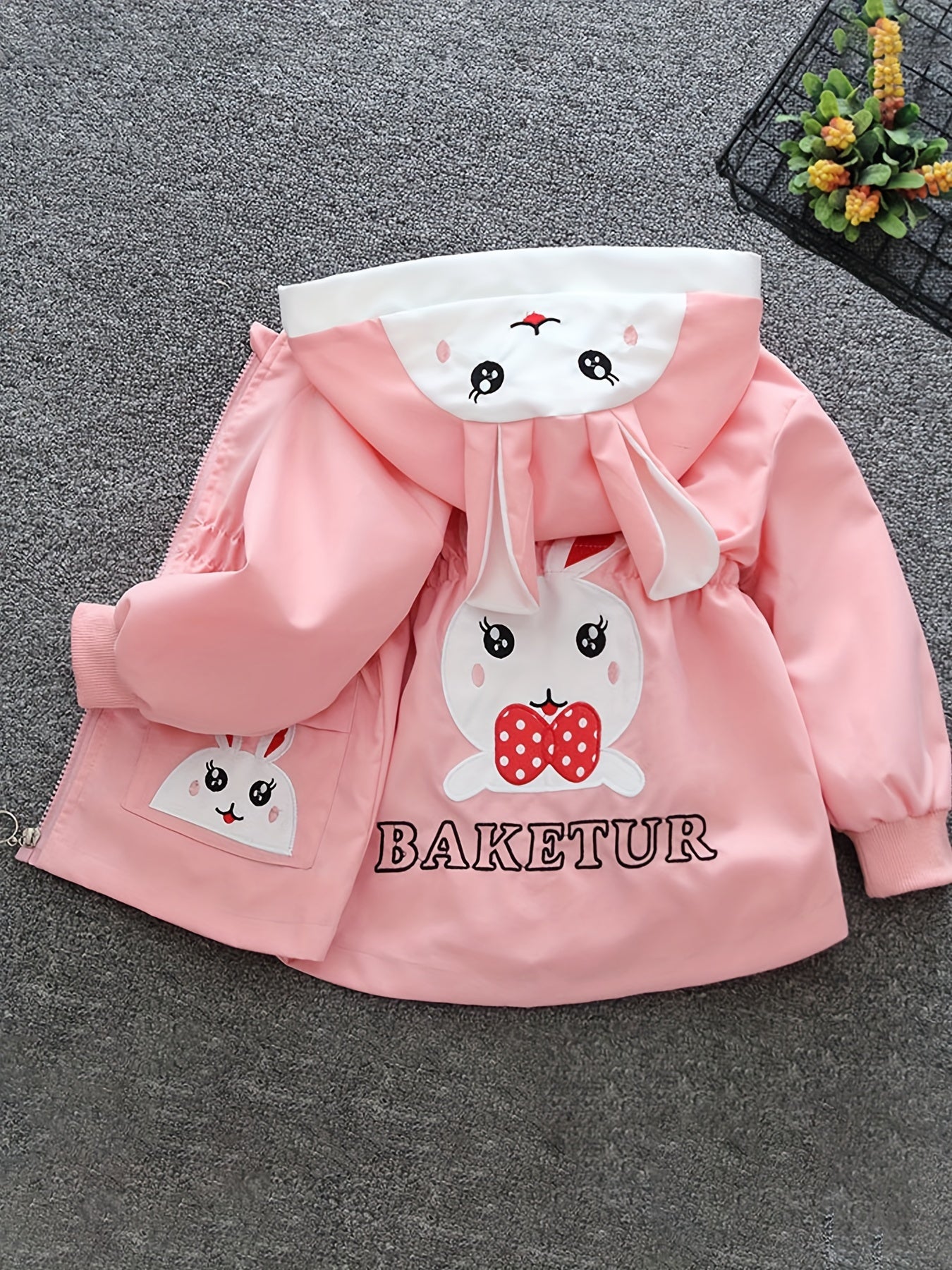 Girls' cute bunny-themed windbreaker in light pink, long sleeve, polyester blend, non-stretch fabric with pockets. Ideal for spring and autumn.