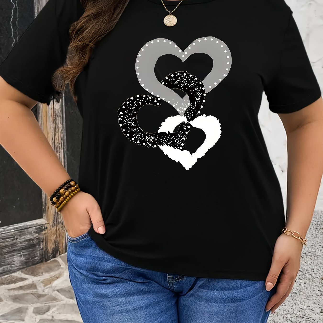 Black heart graphic tee in plus size, soft touch, chic design, crew neck, short sleeve, stretchy polyester blend, machine washable.