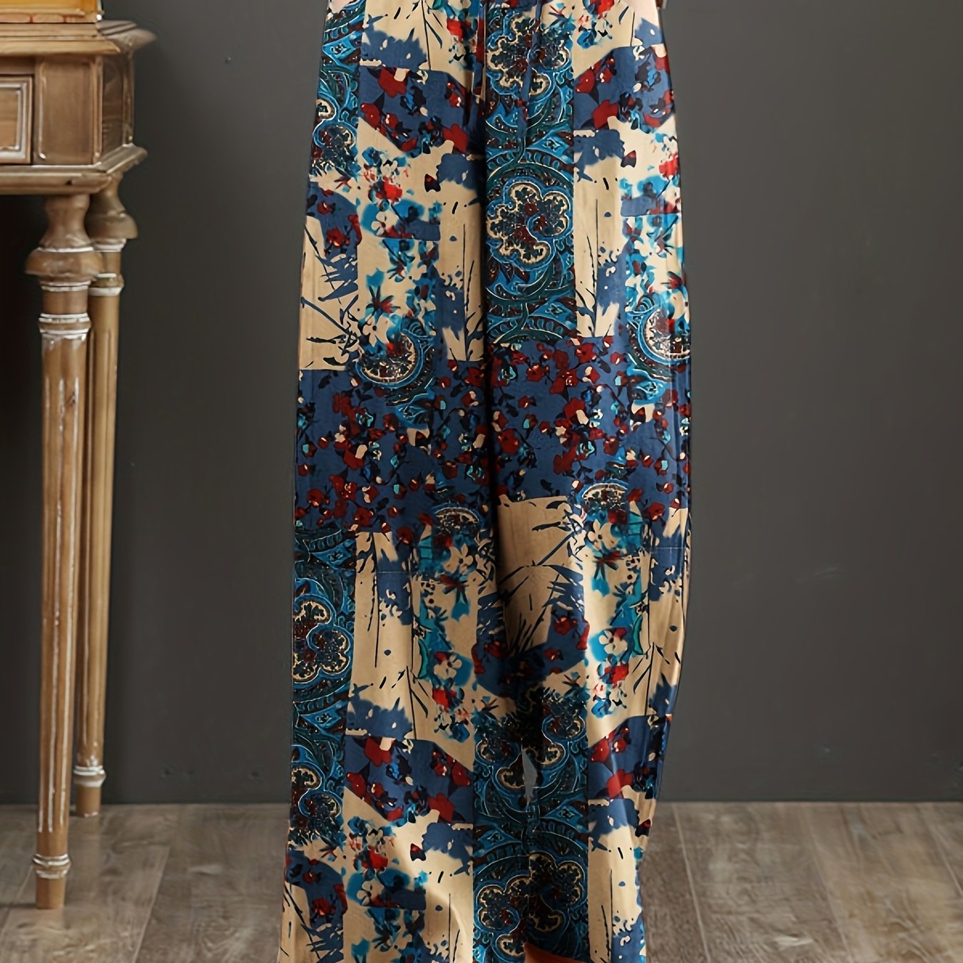 Floral cotton wide-leg pants with elastic waist, lace-up detail, and loose fit. Perfect for casual weekends and year-round comfort. Made with woven fabric for adults.