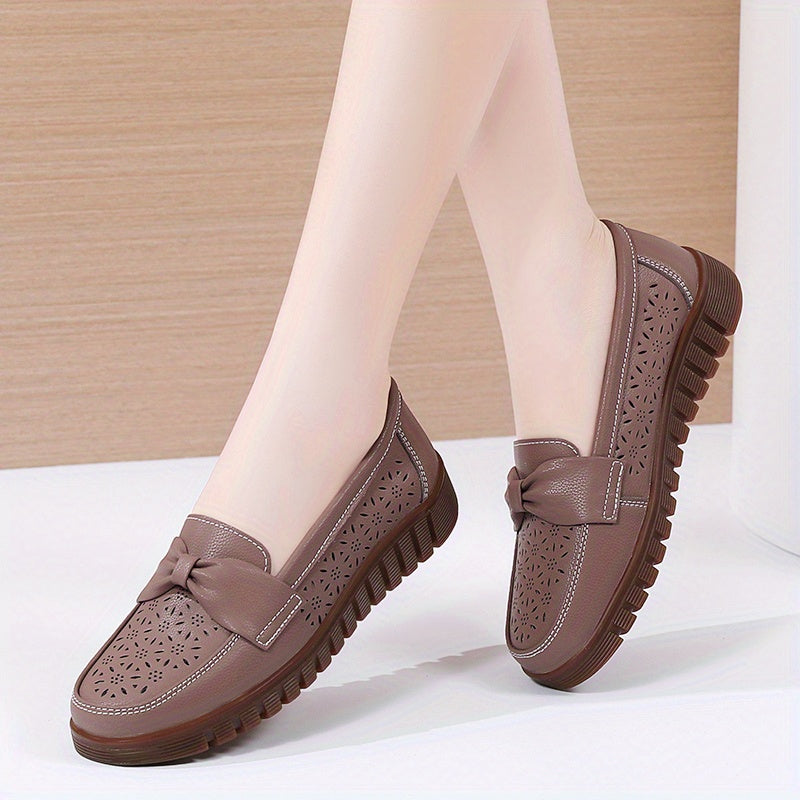 Flat loafers for women with hollow out design, bow detail, soft sole, suitable for casual walking.