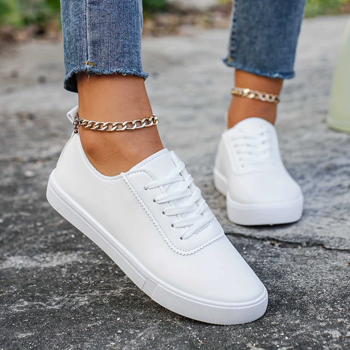 Versatile women's white sneakers with classic design, lace-up closure, round toe, and rubber sole for all seasons. Made with faux leather upper and comfortable fabric lining.