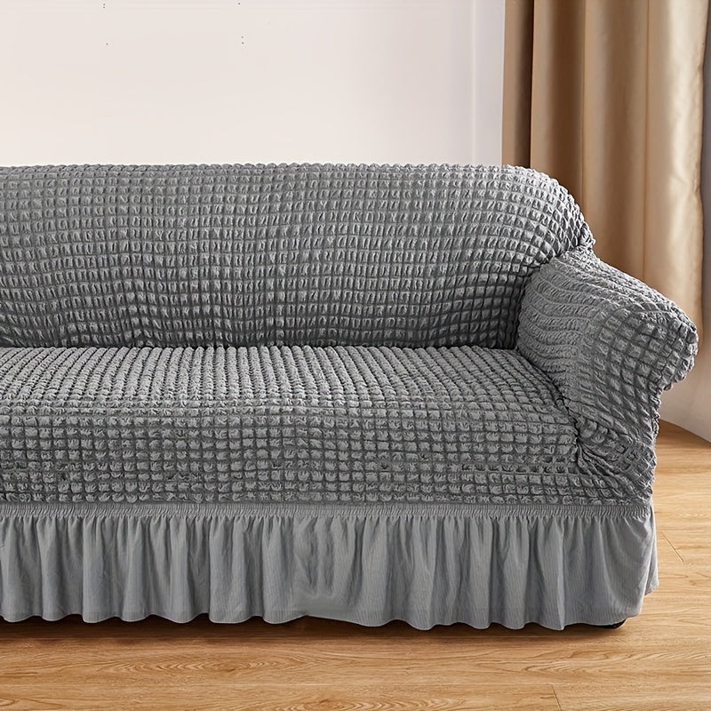 Seersucker skirt sofa cover protects couch from cat scratches in bedroom, office, or living room.