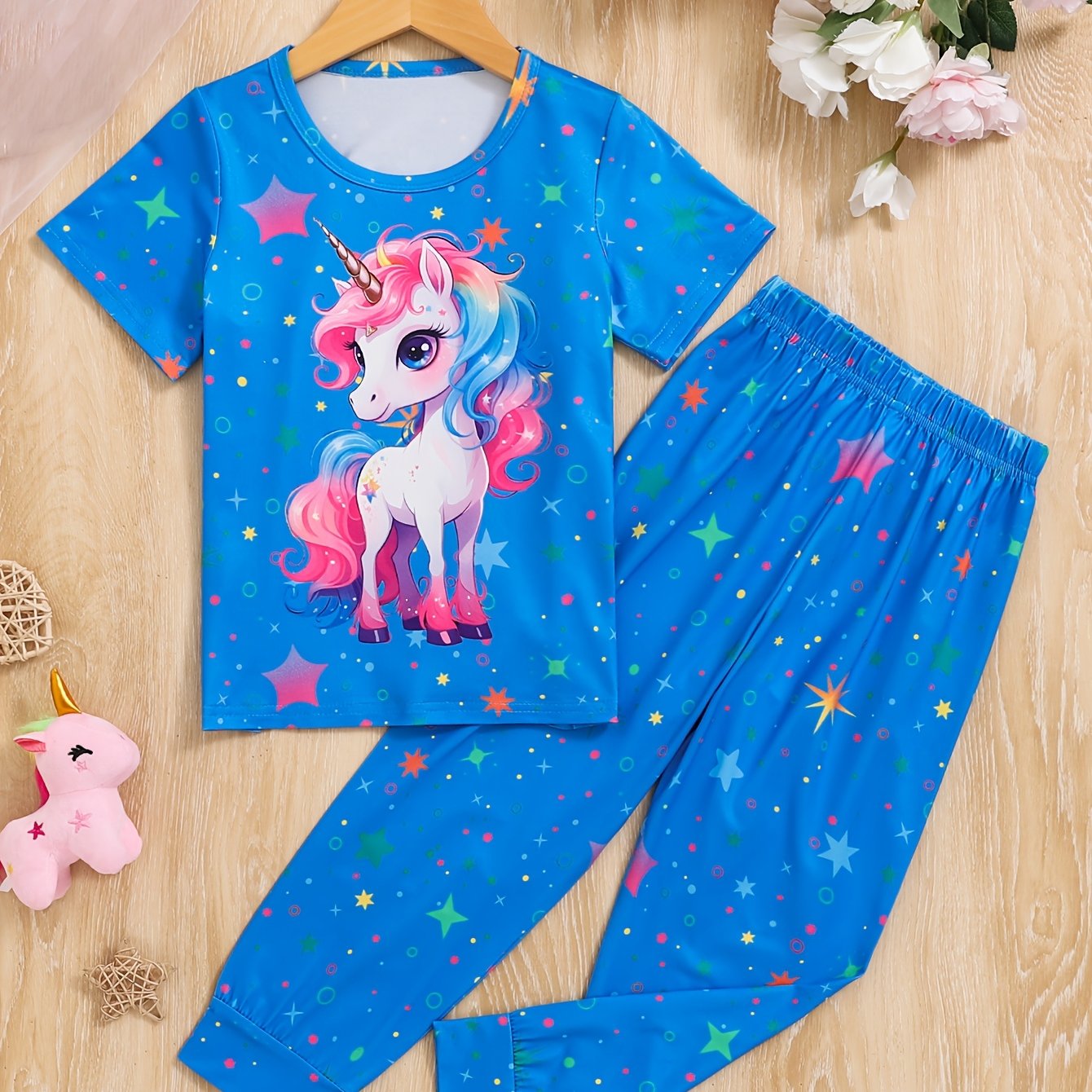 Pink unicorn and star pattern pajama set for girls, flame retardant, cozy short sleeve top and long pants, ideal spring/autumn gift, machine washable.