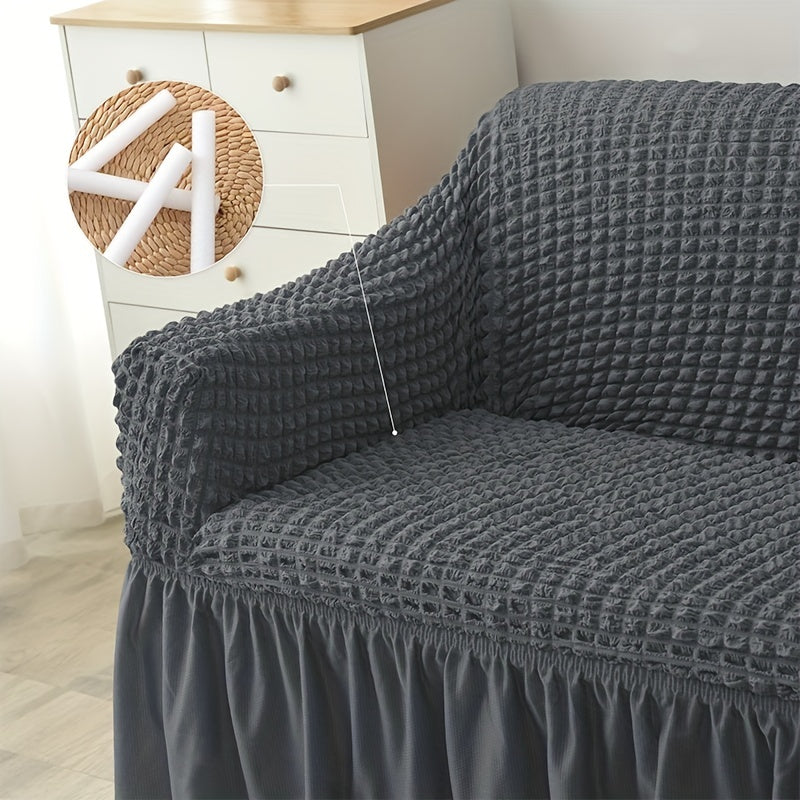 Non-slip elastic sofa cover with skirt for home decor.