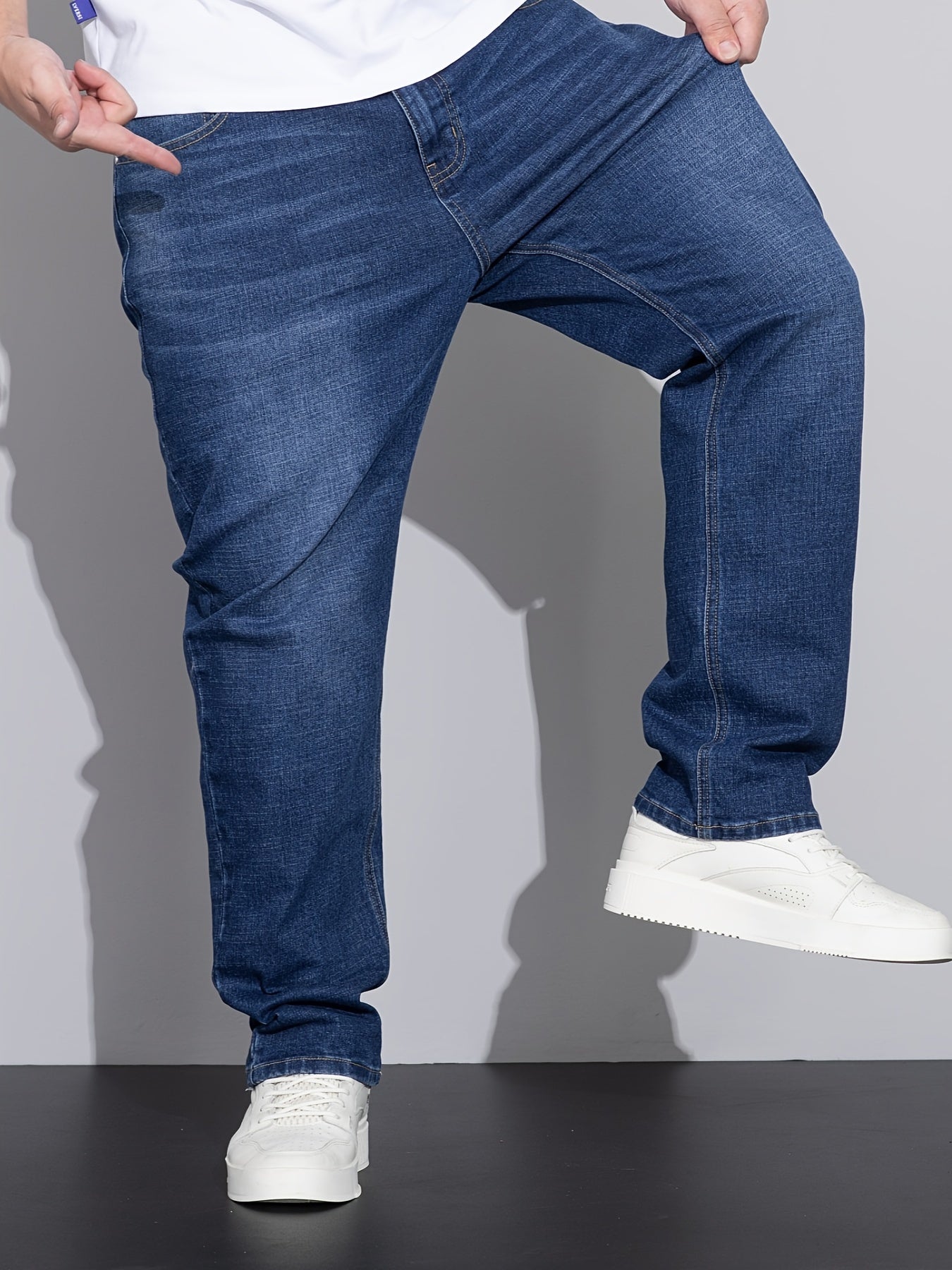 Men's stretchy cotton denim pants for all seasons, in a loose fit and plus size, perfect for business casual wear.