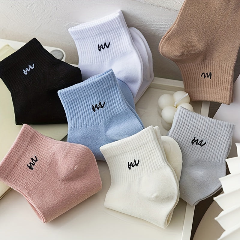 7 pairs of women's mid-calf rib-knit socks in trendy candy colors with solid color and letter detail, made of 95% polyester and 5% spandex. Medium crew length with 300g/m² knit fabric.