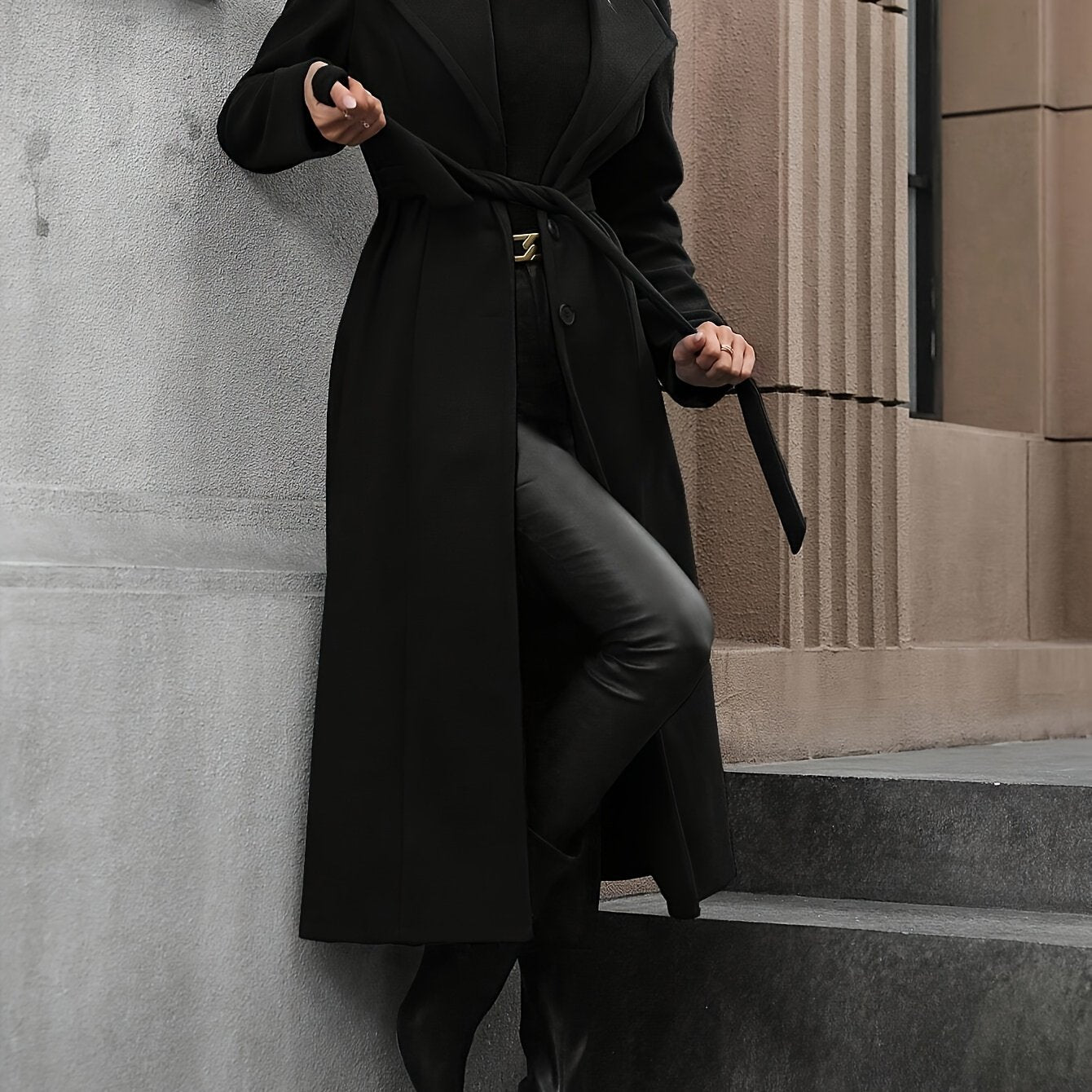 Stylish black trench coat with belt for women's fall/winter outerwear collection.