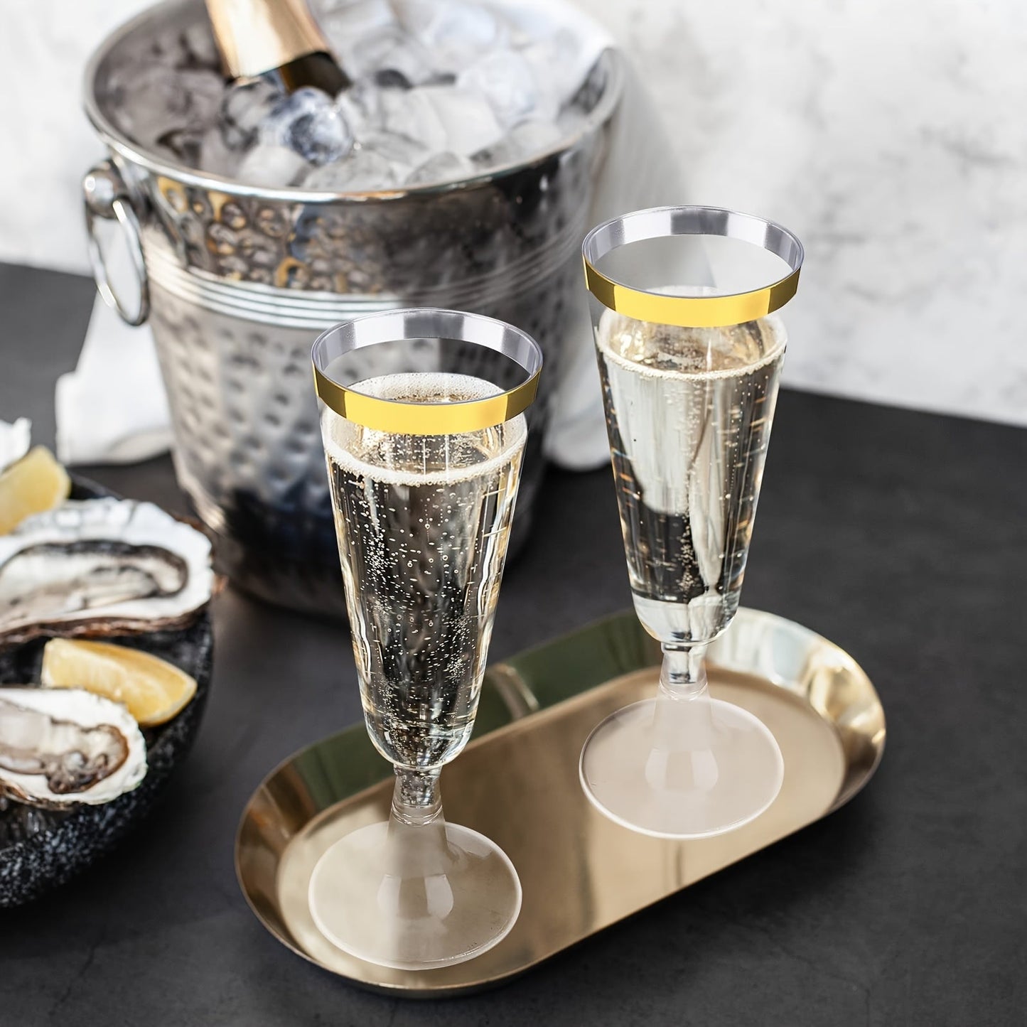 A pack of 25 elegant plastic champagne flutes with golden rims, each holding 5.5 oz. These acrylic mimosa glasses are recyclable and perfect for parties. They are machine washable and can be used for various occasions such as weddings, Christmas