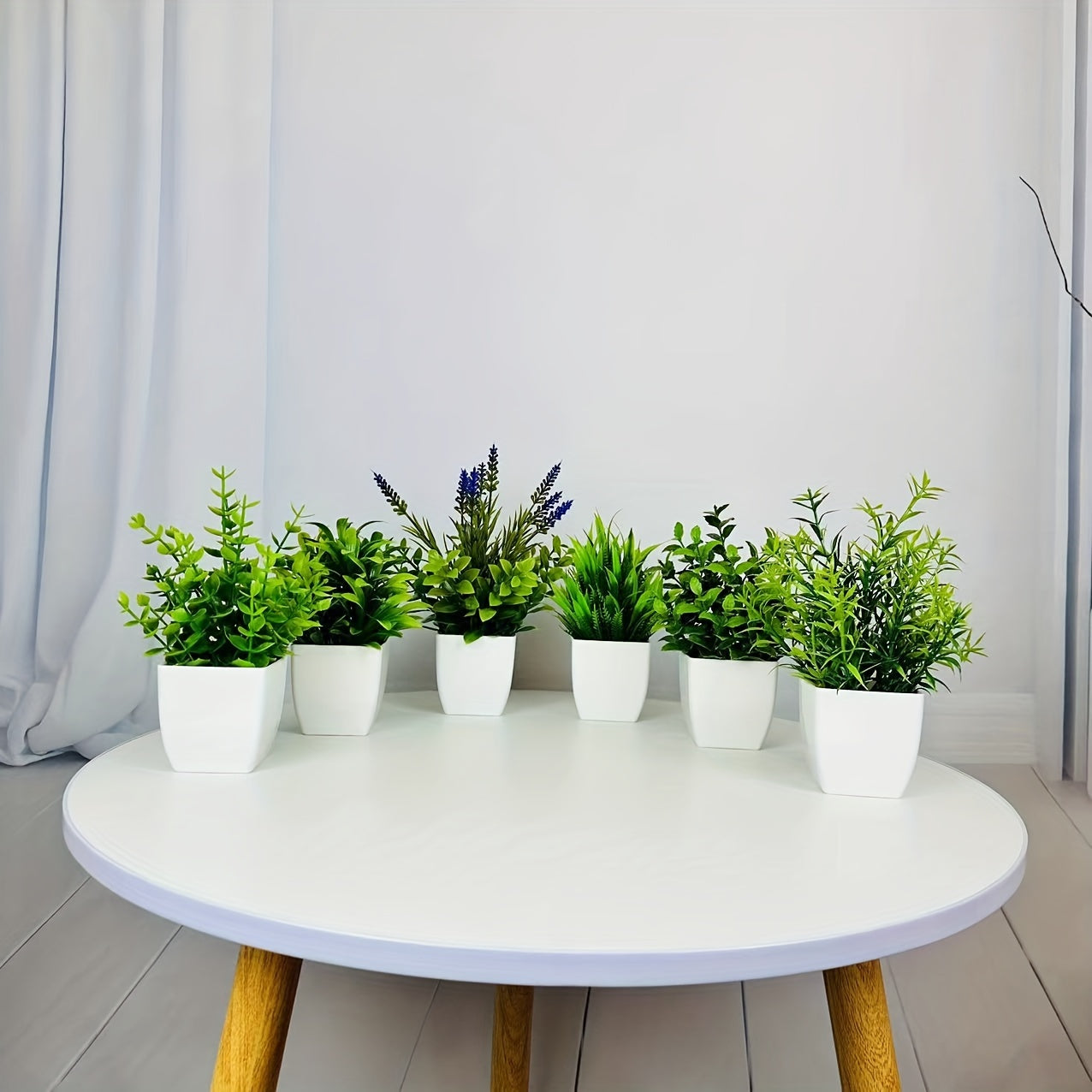 Small artificial white flowerpot with green plant, ideal for indoor home decoration. Can also be used as a mini green plant pot for offices, bathrooms, and bedrooms.