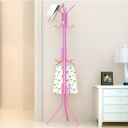 Multi-purpose, freestanding black metal coat rack with tree-style design for hanging clothes and hats in the bedroom.